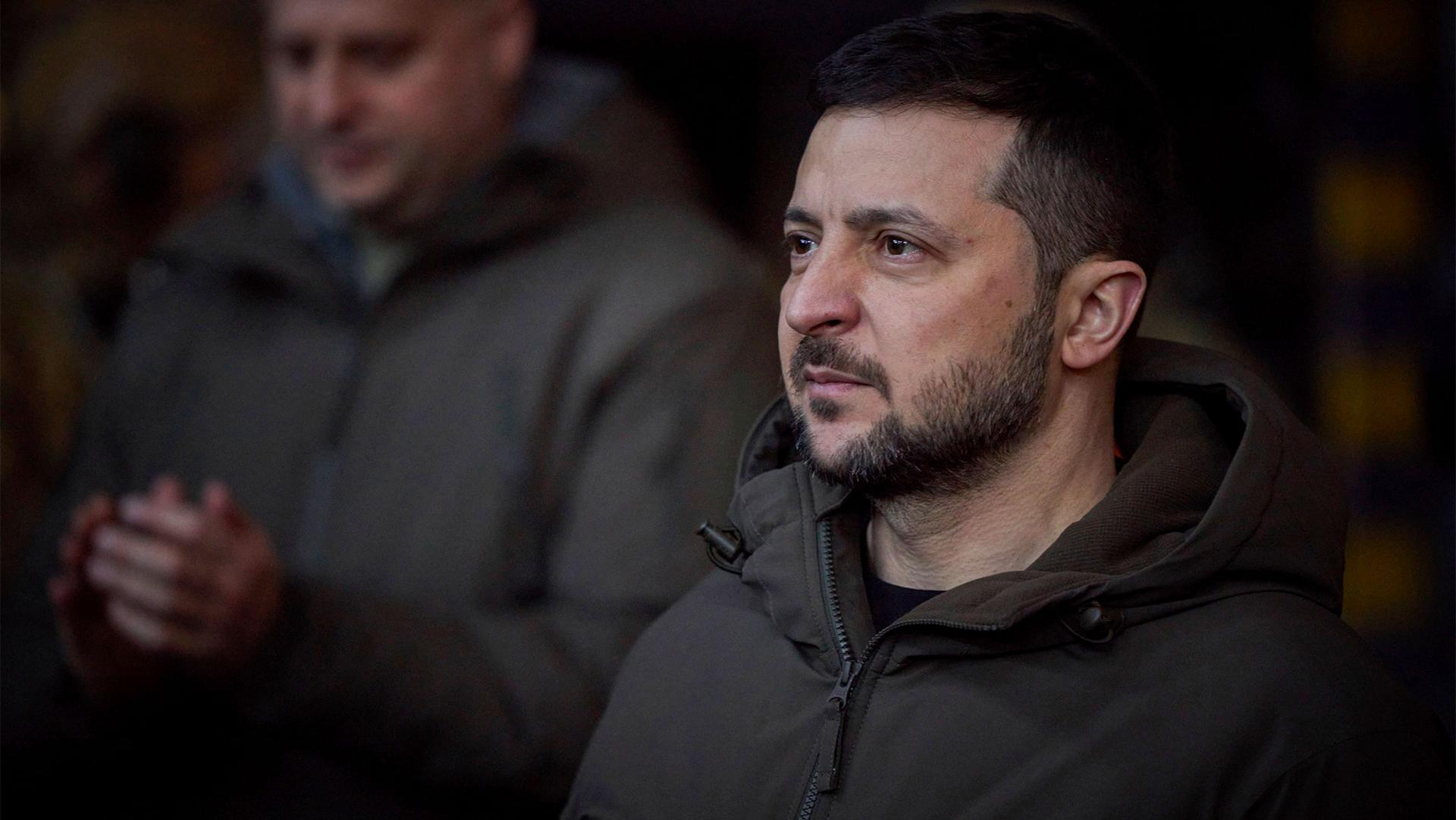 Ukrainian President Volodymyr Zelenskiy looks on as he meets soldiers at the site of the heaviest battles with the Russian invaders in Bakhmut, Ukraine, Dec. 20, 2022.