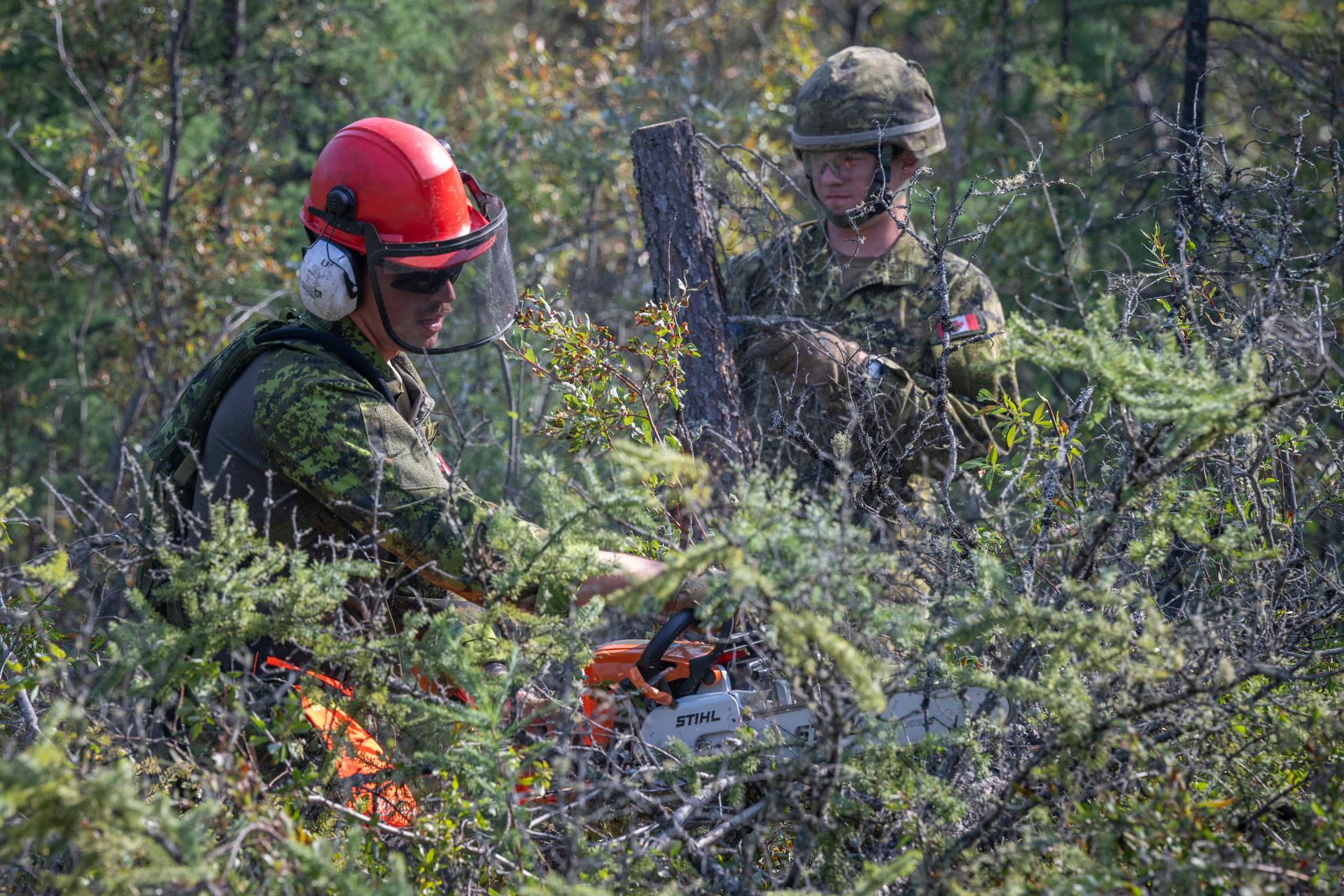 Canadian Armed Forces soldiers construct a firebreak in Parker Recreation Field in Yellowknife to help fight wildfires, Aug. 16, 2023.