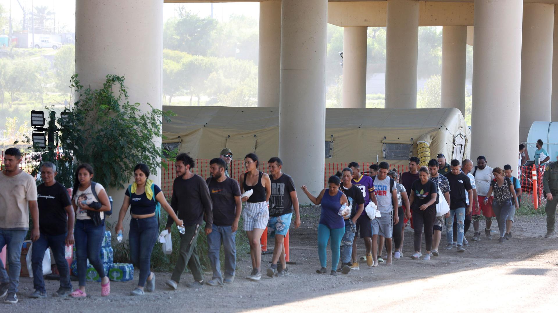 US Border Patrol agents process hundreds of migrants under the International Bridge II in Eagle Pass, Texas, Wednesday, Sept. 20, 2023. 