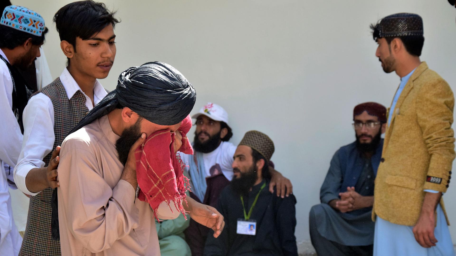 People mourn for their relative, who was killed in a bomb explosion, at a hospital, in Quetta, Pakistan, Friday, Sept. 29, 2023.