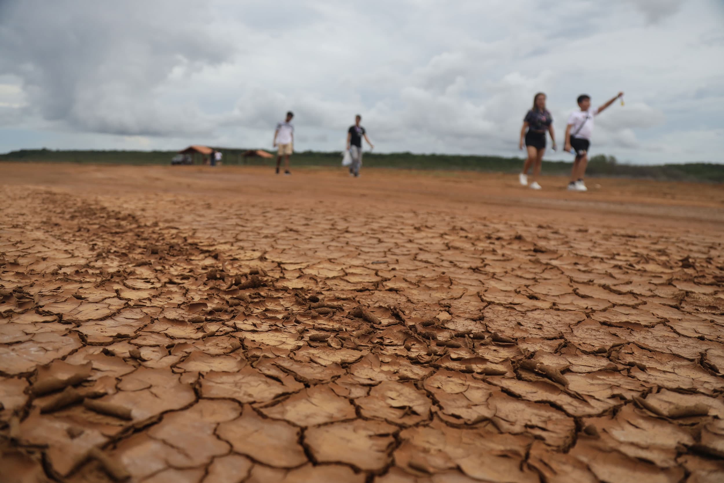 Visitors walk over the dried bed to view the solar eclipse in Panama.