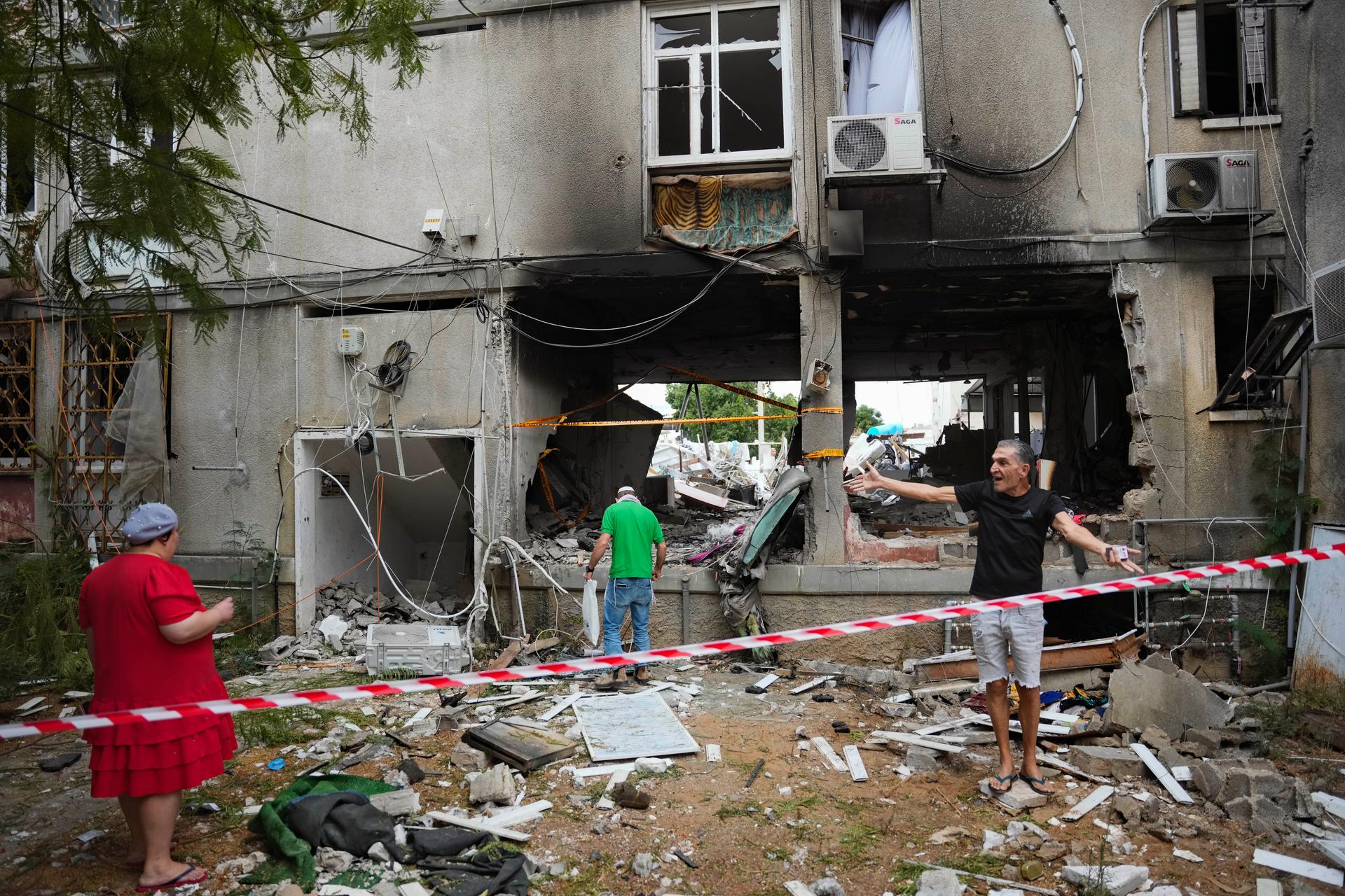 people inspecting rubble