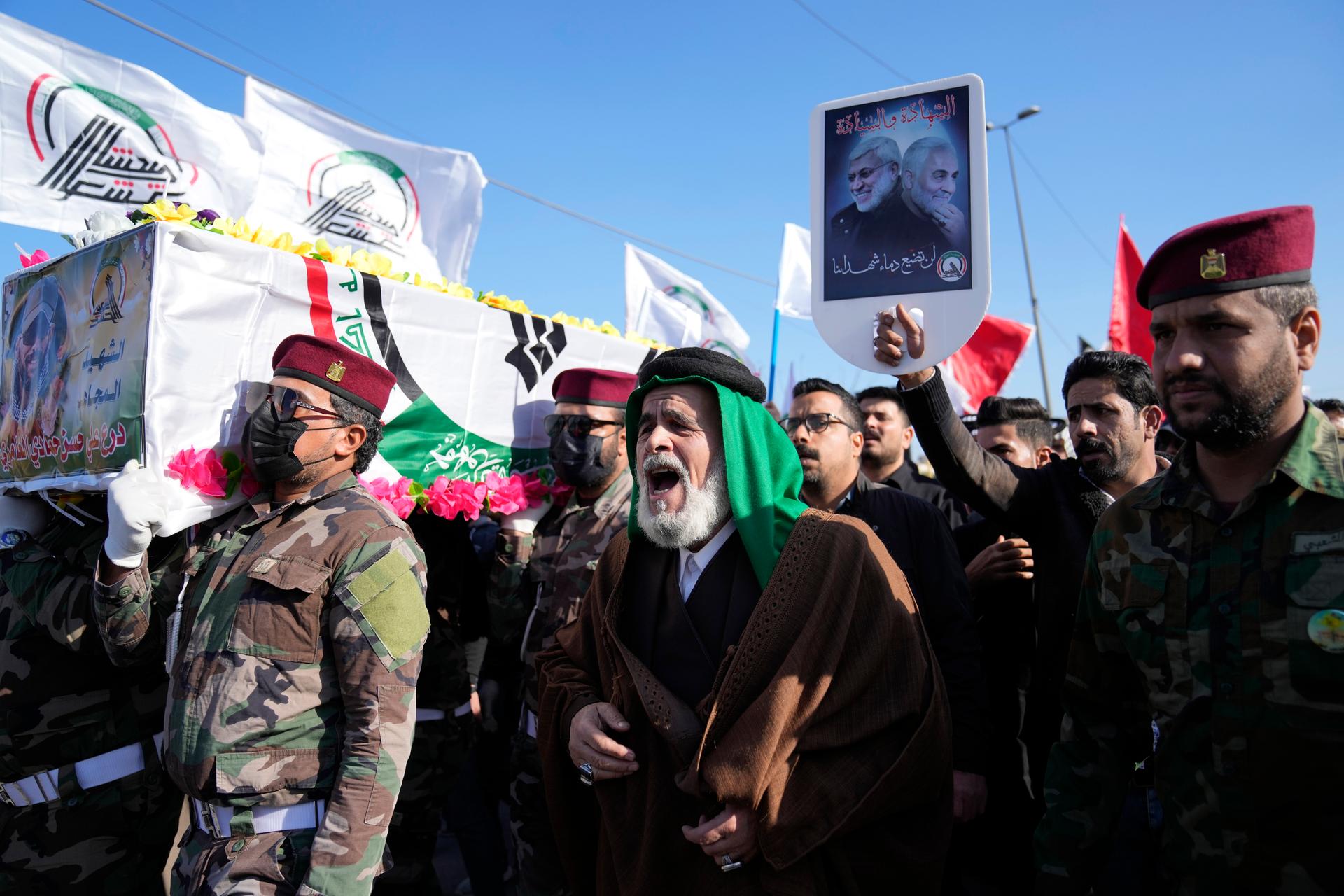 Members of an Iraqi militia group carry the coffin of a Kataib Hezbollah fighter during his funeral in Baghdad, Iraq, who was killed in a US airstrike in Babil Province, Dec. 26, 2023.