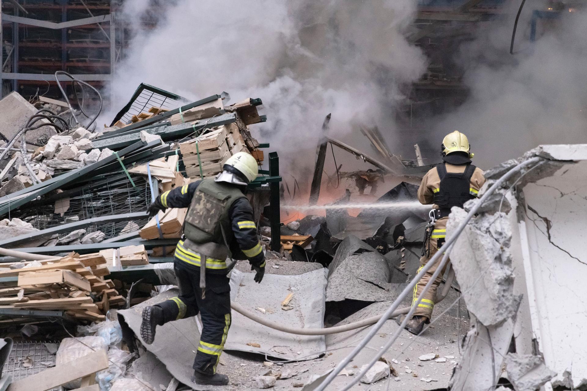 Firefighters work to extinguish a fire after a Russian attack in Kharkiv, Ukraine, Dec. 29, 2023.