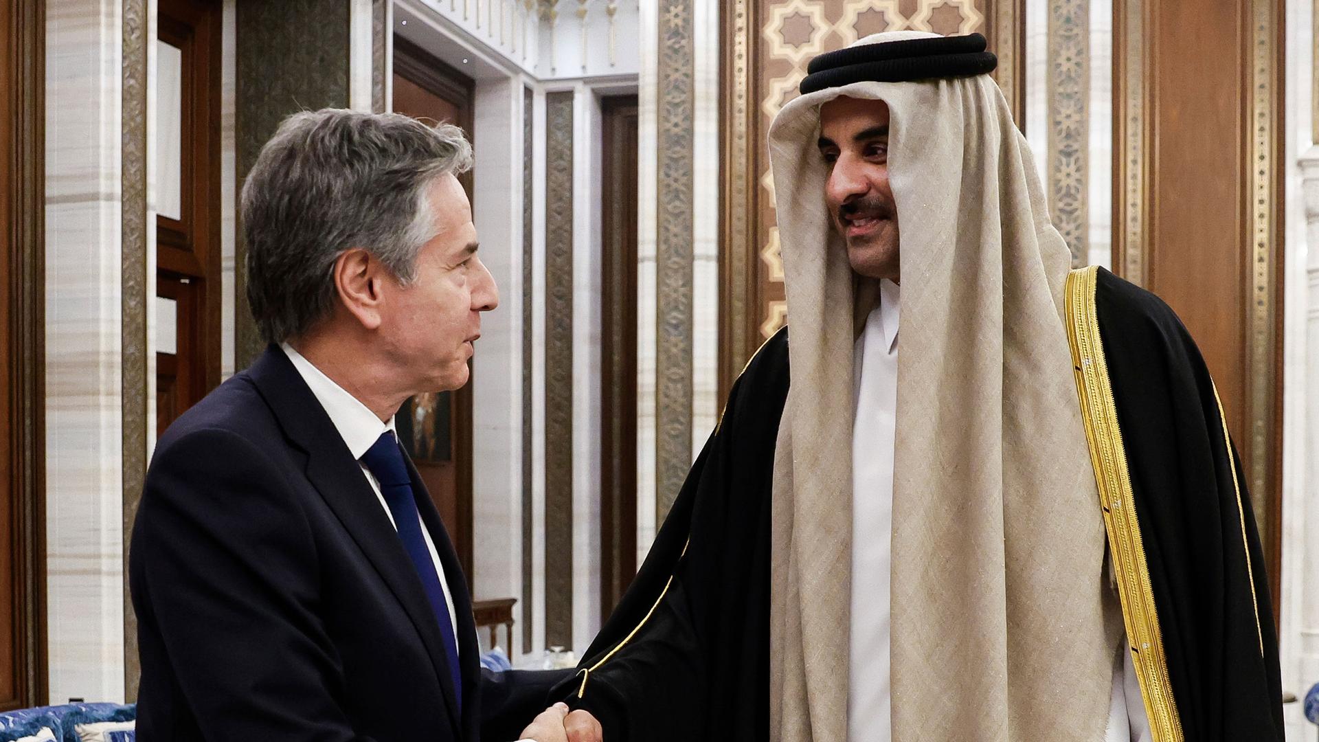 US Secretary of State Antony Blinken, left, shakes hands with Qatar's Emir Sheikh Tamim Bin Hamad al-Thani, during Blinken's week-long trip aimed at calming tensions across the Middle East, at Lusail Palace in Lusail, Qatar, Sunday, Jan. 7, 2024.