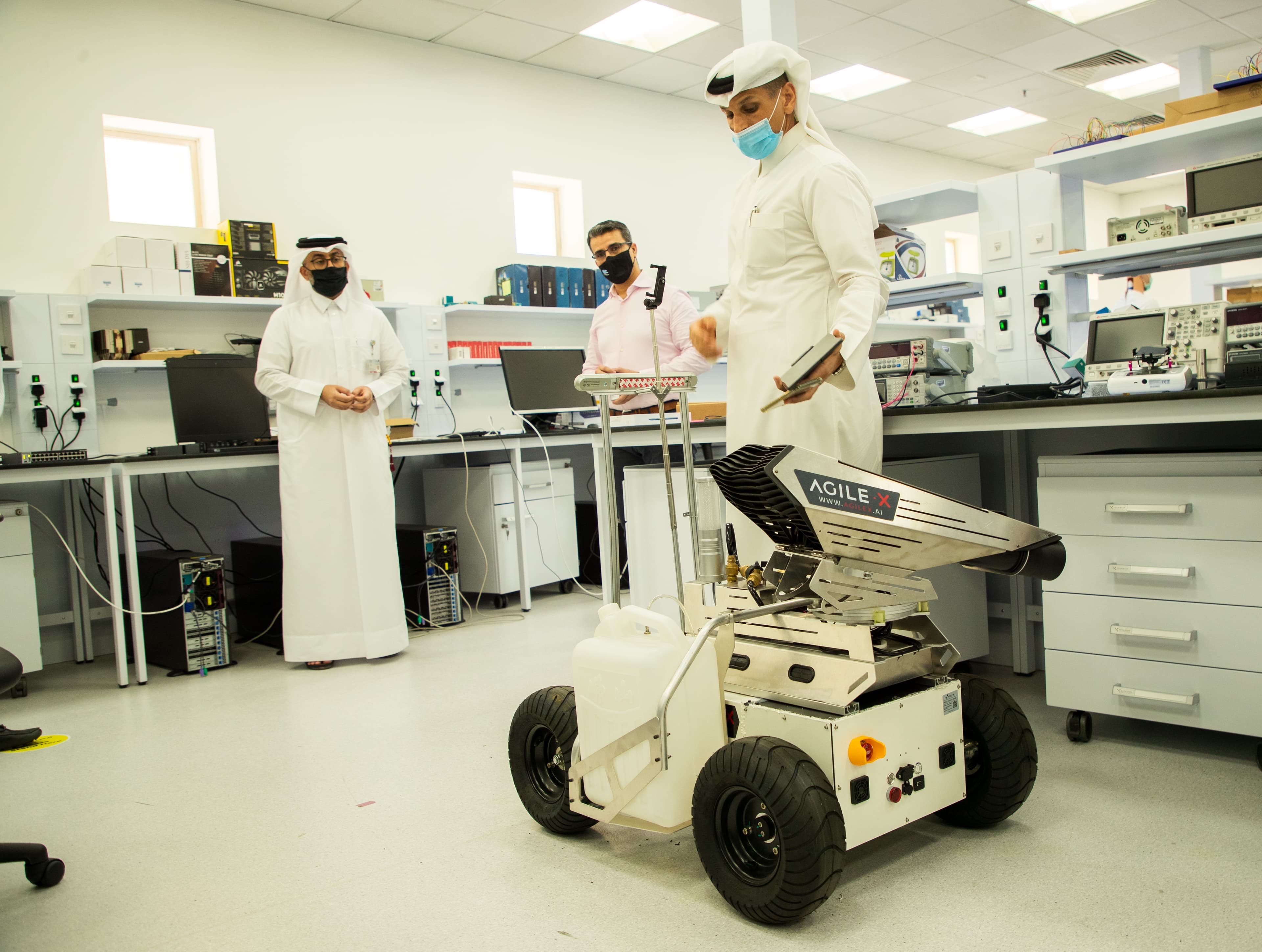 students in the lab with a robot