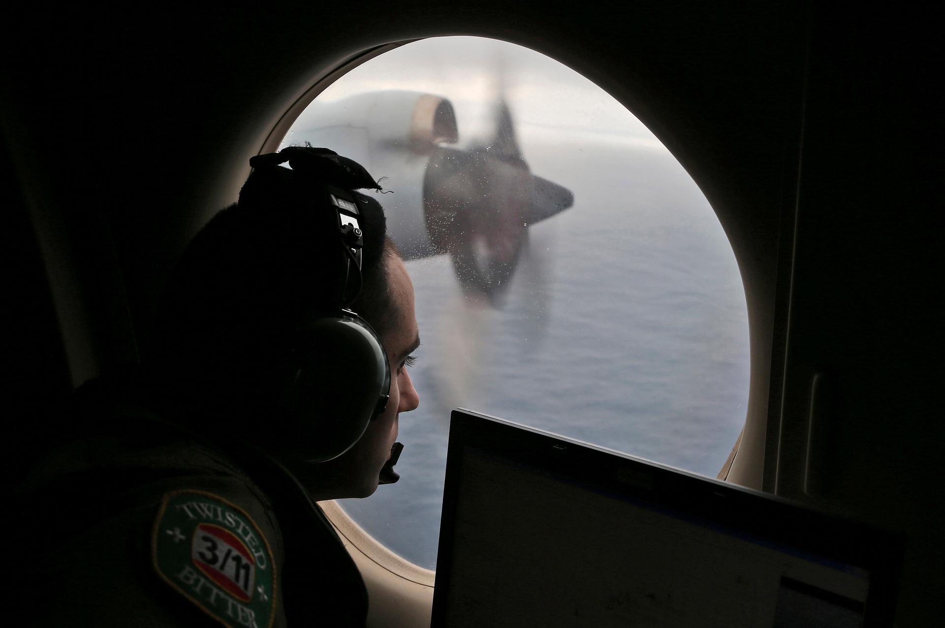 Flight officer Rayan Gharazeddine scans the water in the southern Indian Ocean off Australia from a Royal Australian Air Force AP-3C Orion during a search for the missing Malaysia Airlines Flight MH370 on March 22, 2014.