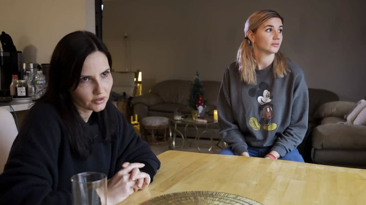 Inna Karpenko, Nika's mother (left), translates for Oksana Shpakovych, Artem's mother (right). Their families share a home in Maple Grove and made a pact to live together for at least a year after fleeing the war in Ukraine.