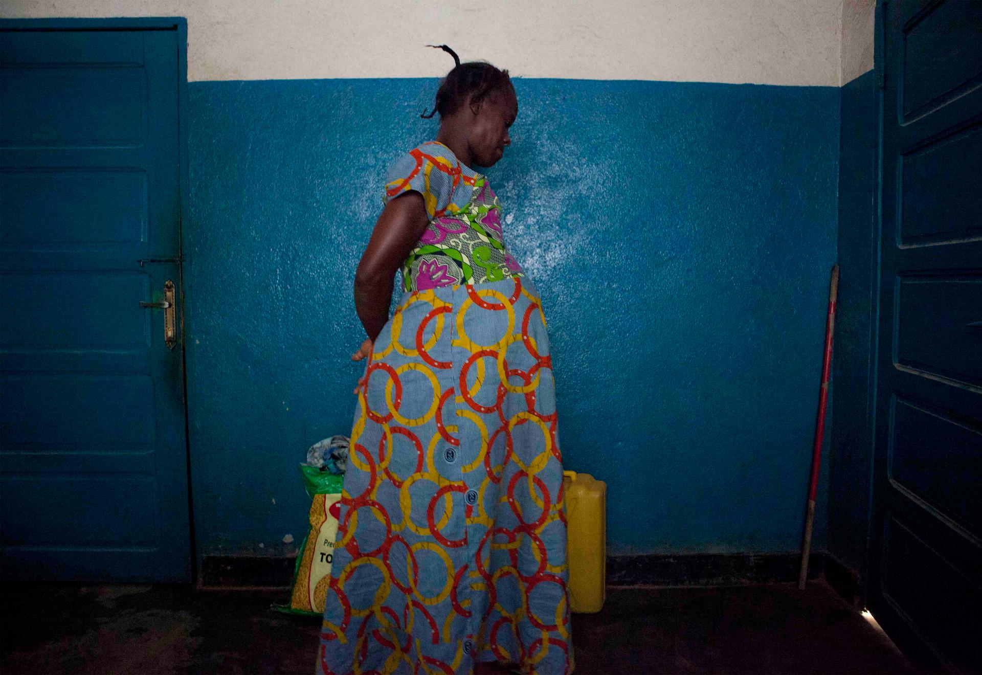 Elali Bao paces during the early stages of labor at a maternity clinic in North Kivu province.