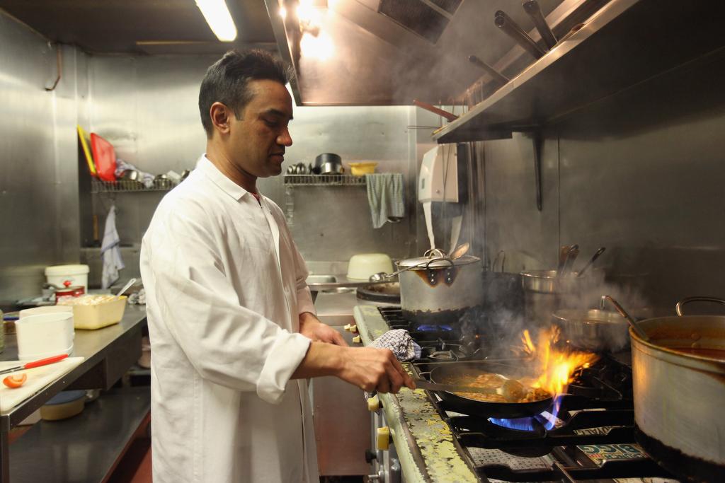 A chef cooks a lamb curry at Cafe Bangla curry house on Brick Lane in London on March 16, 2011.