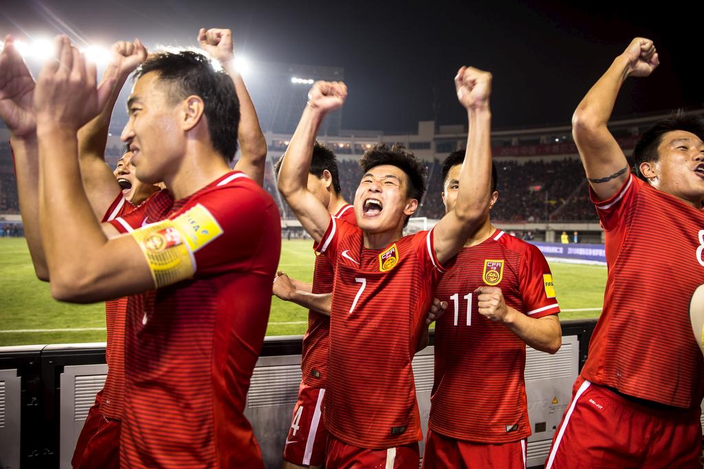 China's national soccer team celebrates after defeating Qatar 2-0 at Shaanxi Province Stadium in Xi'an, China, on March 29, 2016.