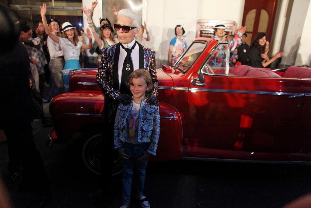 Karl Lagerfeld poses with a model after the show at the Paseo del Prado street in Havana, Cuba, on May 3, 2016.