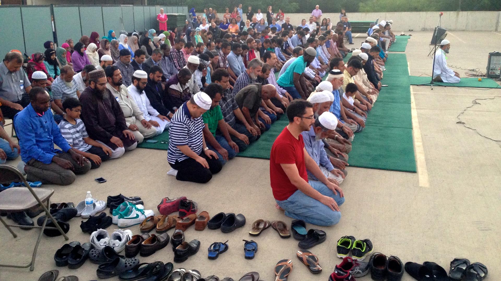 Evening prayers were held outside the mosque, while members of the public looked on.