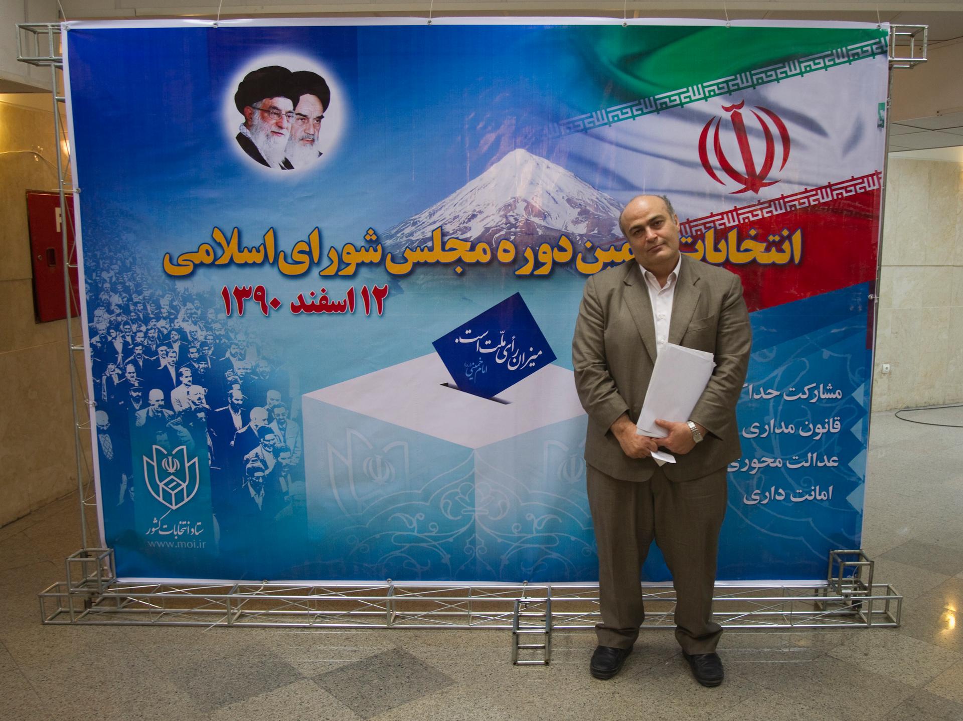 Iranian-Jewish minority Member of Parliament, Siamak Moreh Sedgh, poses for a photograph in front of a banner for the 2012 parliamentary elections.