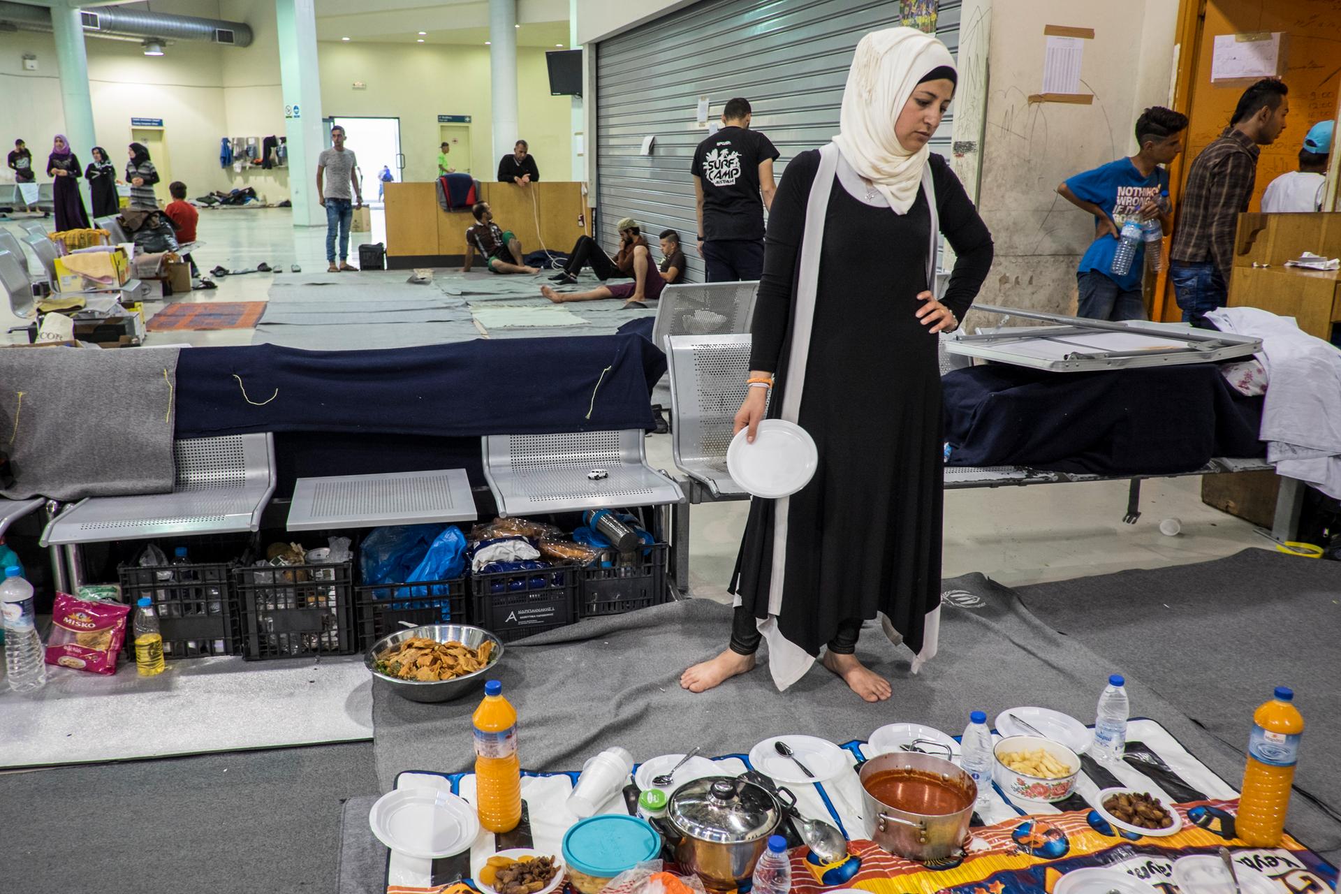 Renna Ramadan prepared an iftar meal for her family, Syrians from Idlib who hoped to reach Northern Europe but instead are living in the passenger waiting area at Piraeus Port Terminal 1 in Athens, Greece. Several hundred refugees and migrants remain at P