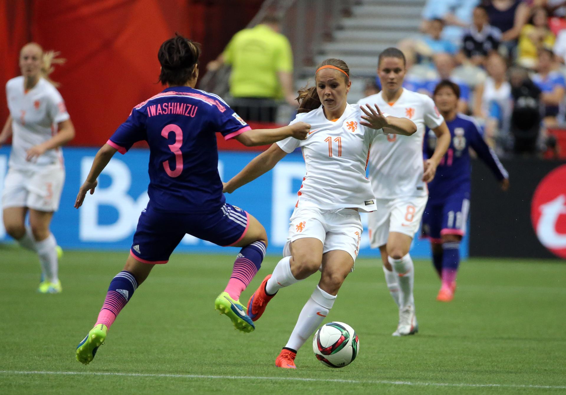 Netherlands forward Lieke Martens (11) controls the ball against Japan defender Azusa Iwashimizu (3) during the second half in the round of sixteen in the FIFA 2015 women's World Cup soccer tournament at BC Place Stadium.