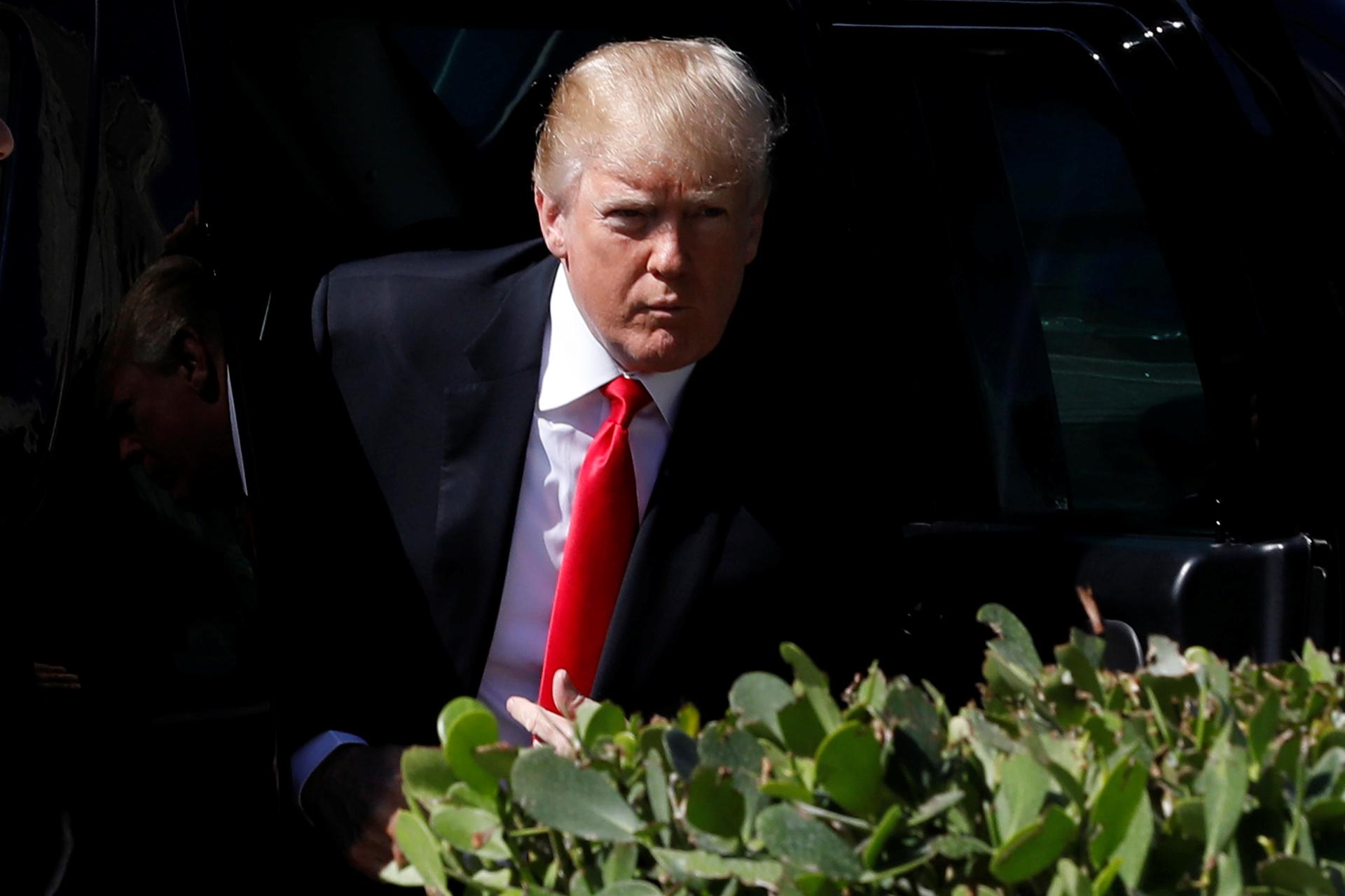 US President Donald Trump arrives for the Easter service at Bethesda-by-the-Sea Episcopal Church