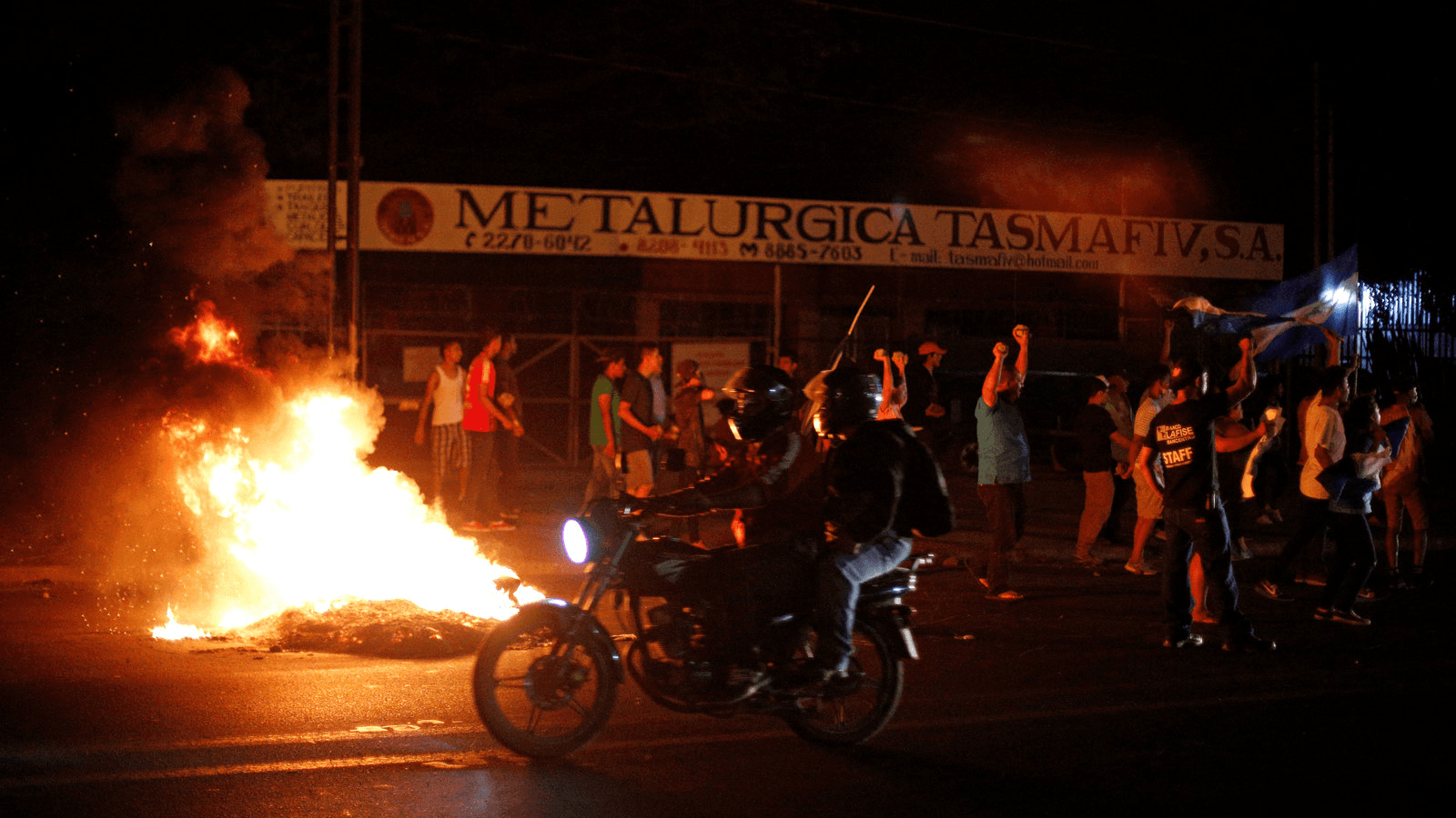 Demonstrators shout next to a burning barricade as they take part in a protest over a controversial reform to the pension plans of the Nicaraguan Social Security Institute (INSS) in Managua, Nicaragua April 21, 2018.