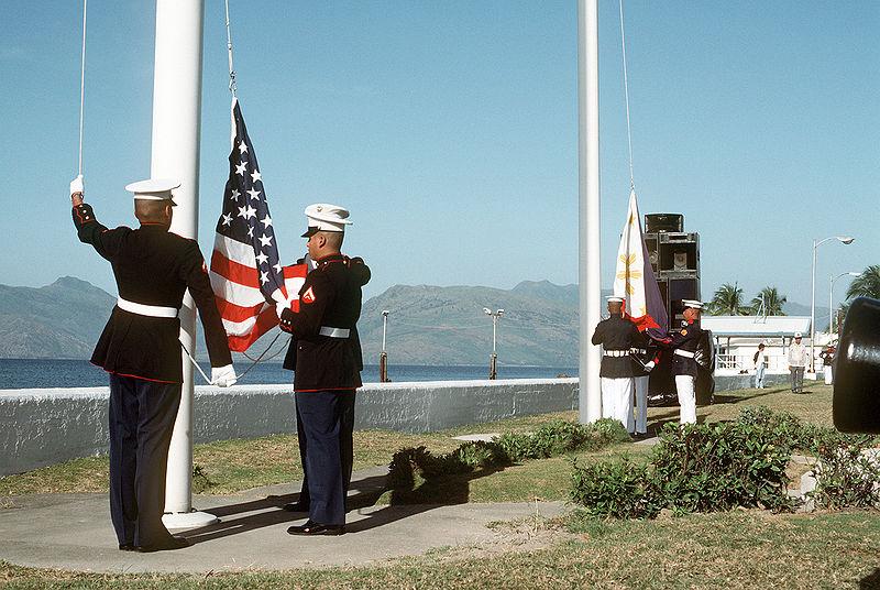 US Marines raise the American flag for the last time at Subic Bay naval base in the Philippines, as their Philippine counterparts raise their ensign for the first time, at the start of the base de-activation ceremony, November 24th, 1992.