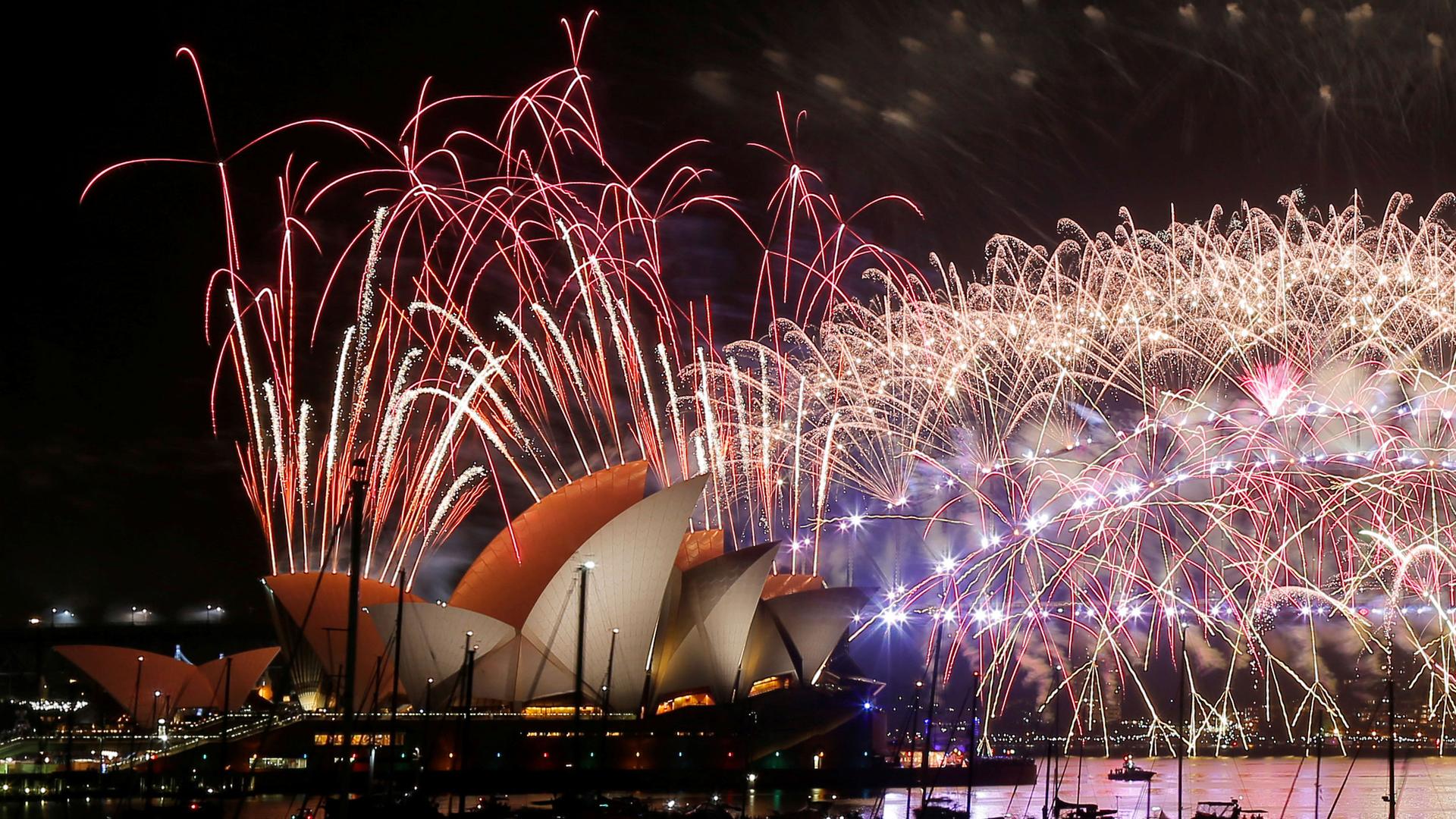 Fireworks explode over the Sydney Opera House as Australia ushers in the New Year.