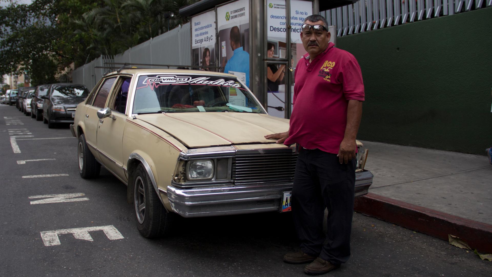 William Rivas drives his own Chevy Malibu as cab. Gas prices are so low in Venezuela that it costs him less than $1 to fill up the tank.