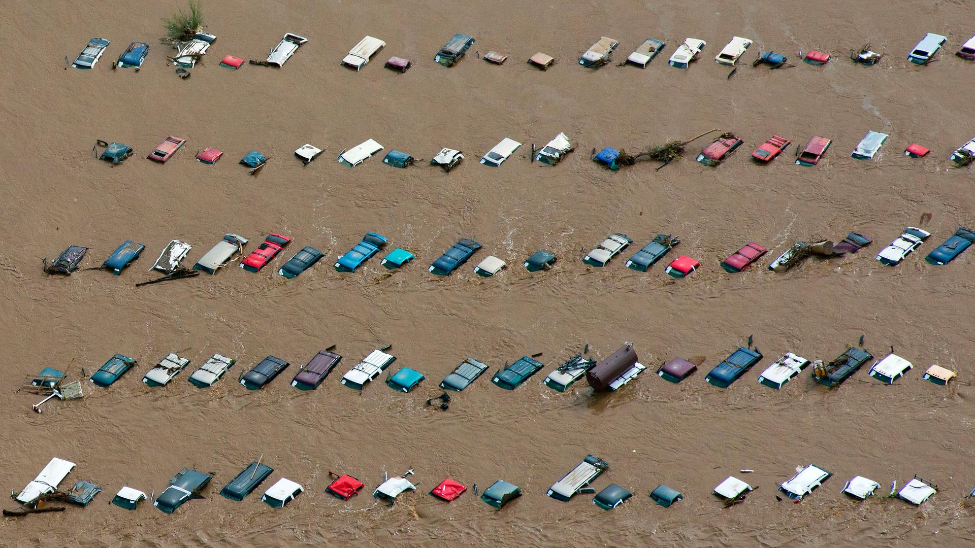 Vehicles submerged in flood waters along the South Platte River near Greenley, Colorado in 2013. Scientists believe climate change is already bringing more flooding to river corridors and coastal areas around the world.