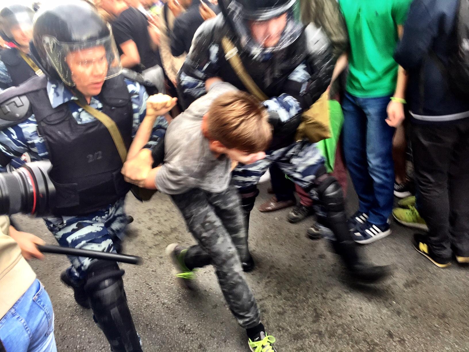 A young protester in Russia being arrested by police.
