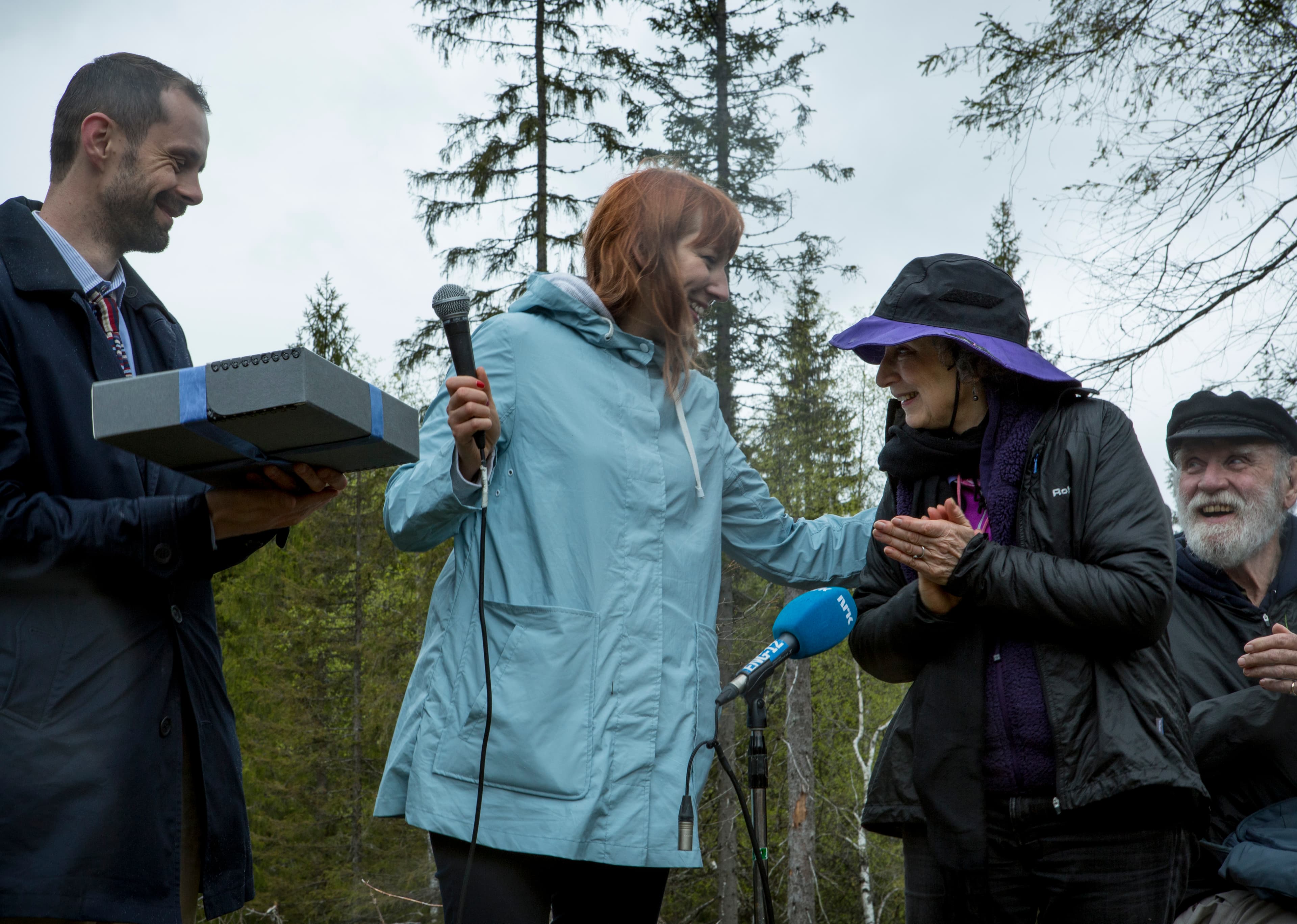 Margaret Atwood, right, hands over her transcript for Future Library, a 100-year project by Scottish artist Katie Paterson, left.