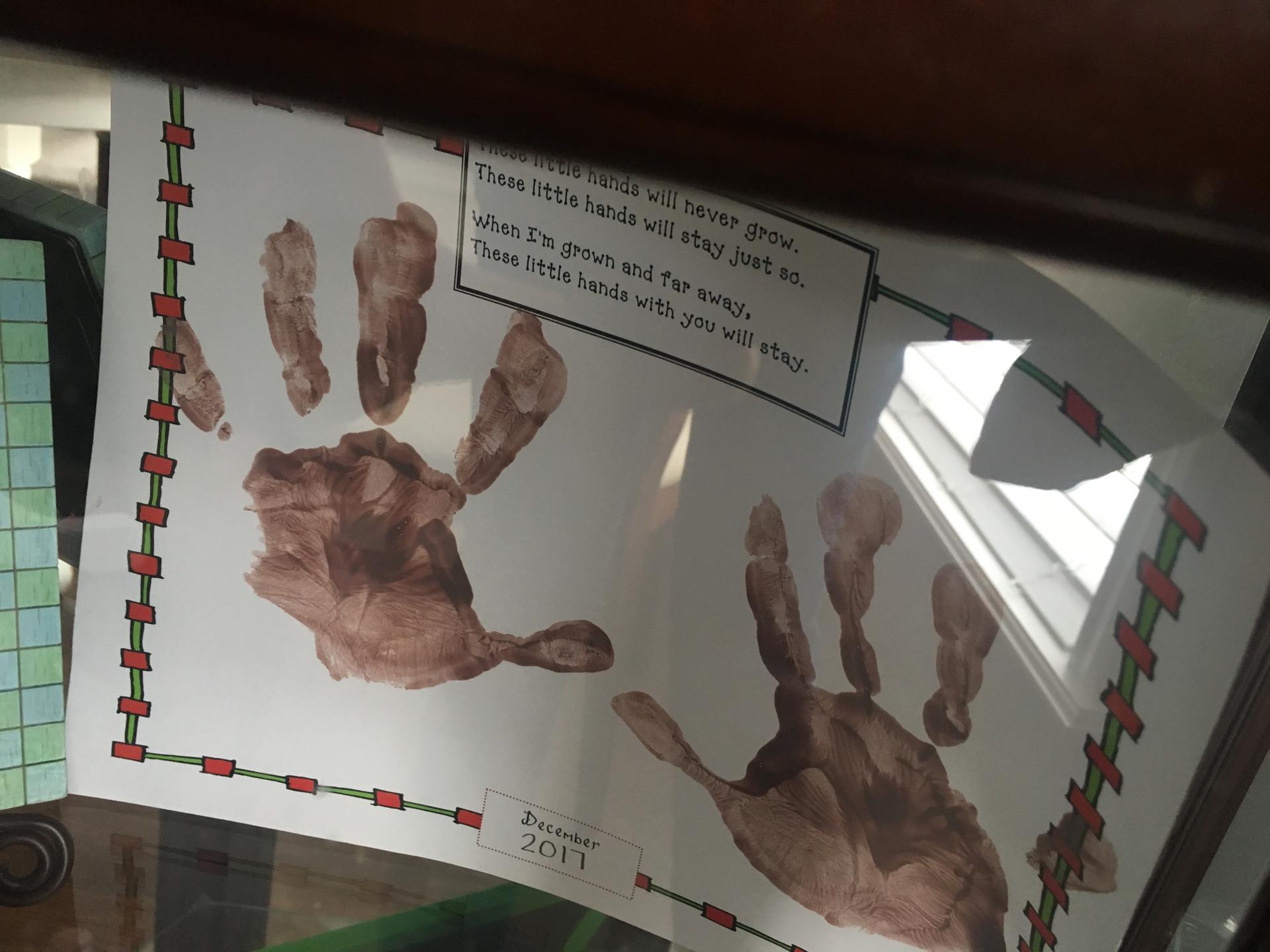 School project of child's hand prints with poem, "When I'm grown and far away, these little hands with you will stay"