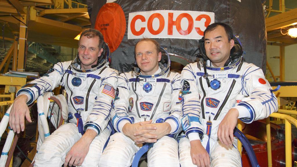 At the Baikonur Cosmodrome in Kazakhstan, ISS Expedition 22 crew members take a moment for photographs following a fit check of their Soyuz TMA-17 spacecraft at the launch site’s integration facility in December 2009.