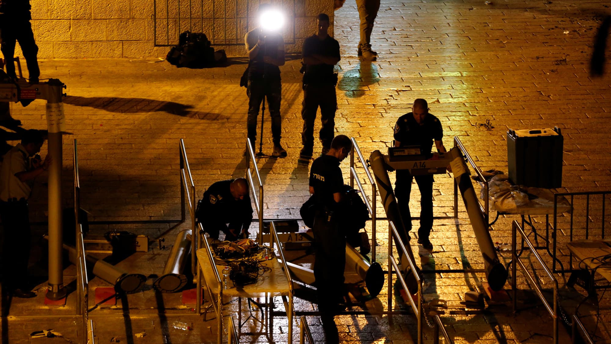 Israeli security forces remove metal detectors which were recently installed at an entrance to the compound known to Muslims as Noble Sanctuary and to Jews as Temple Mount in Jerusalem's Old City.