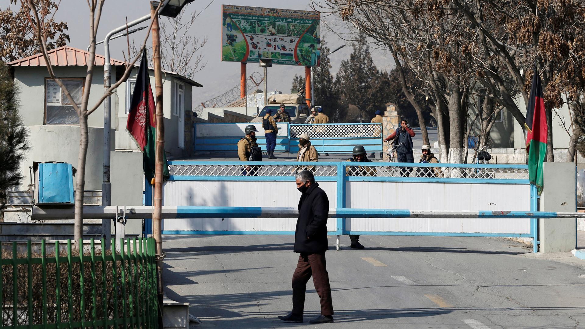 Afghan security forces stand guard at the entrance gate of the Intercontinental Hotel a day after an attack in Kabul, Afghanistan, Jan. 22, 2018.