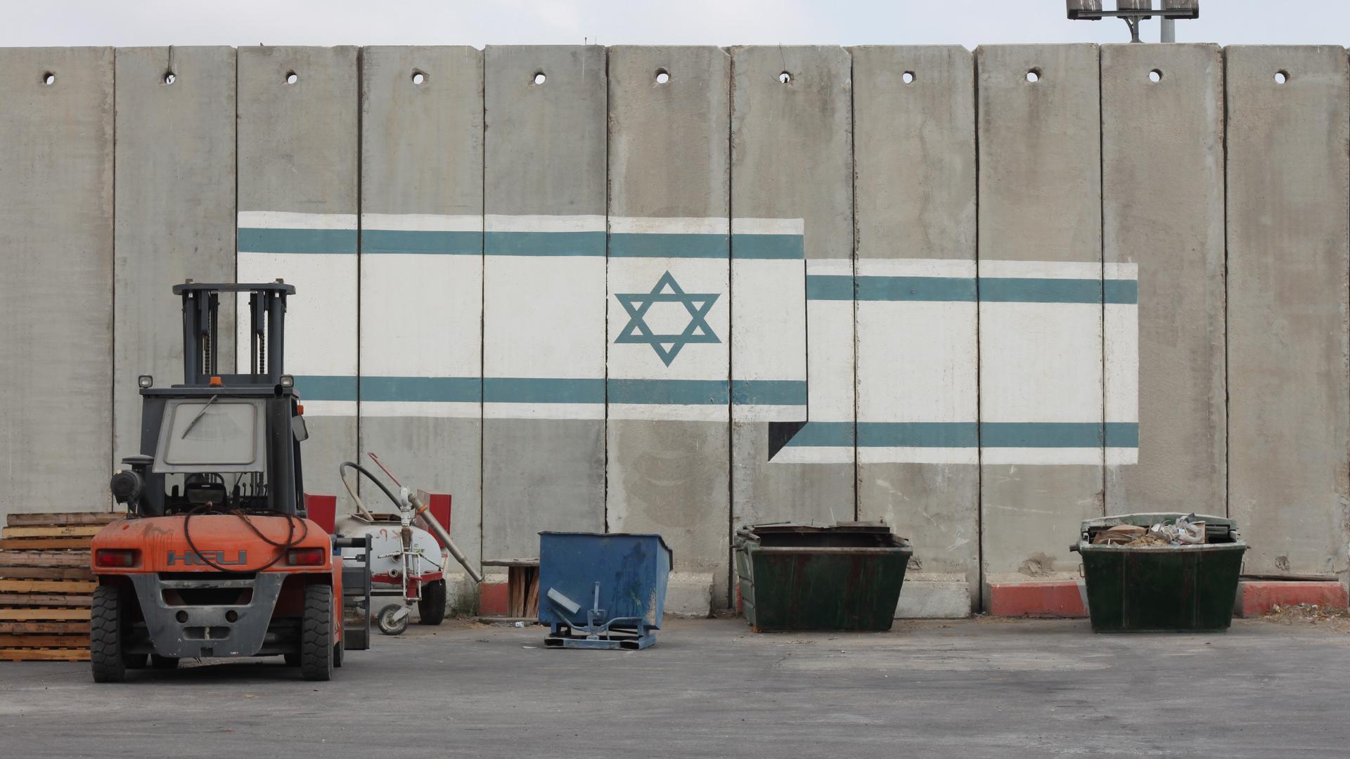 An Israeli flag is painted on one of the walls on the Israeli side of the Kerem Shalom crossing into Gaza.