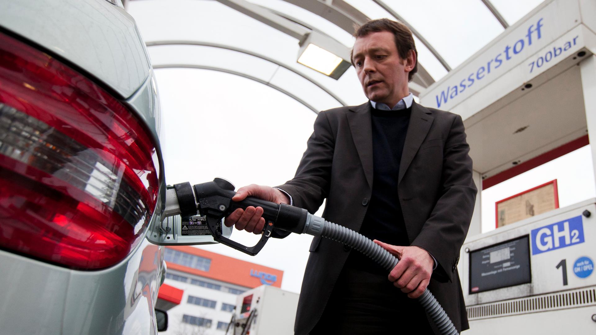 Lutz Wiese of Vattenfall power company refuels a hydrogen-powered Mercedes at a filling station in Berlin. Vatenfall is a partner in the world's first direct wind-hydrogen power plant, in northern Germany. Using wind-generated electricity to create hydrog