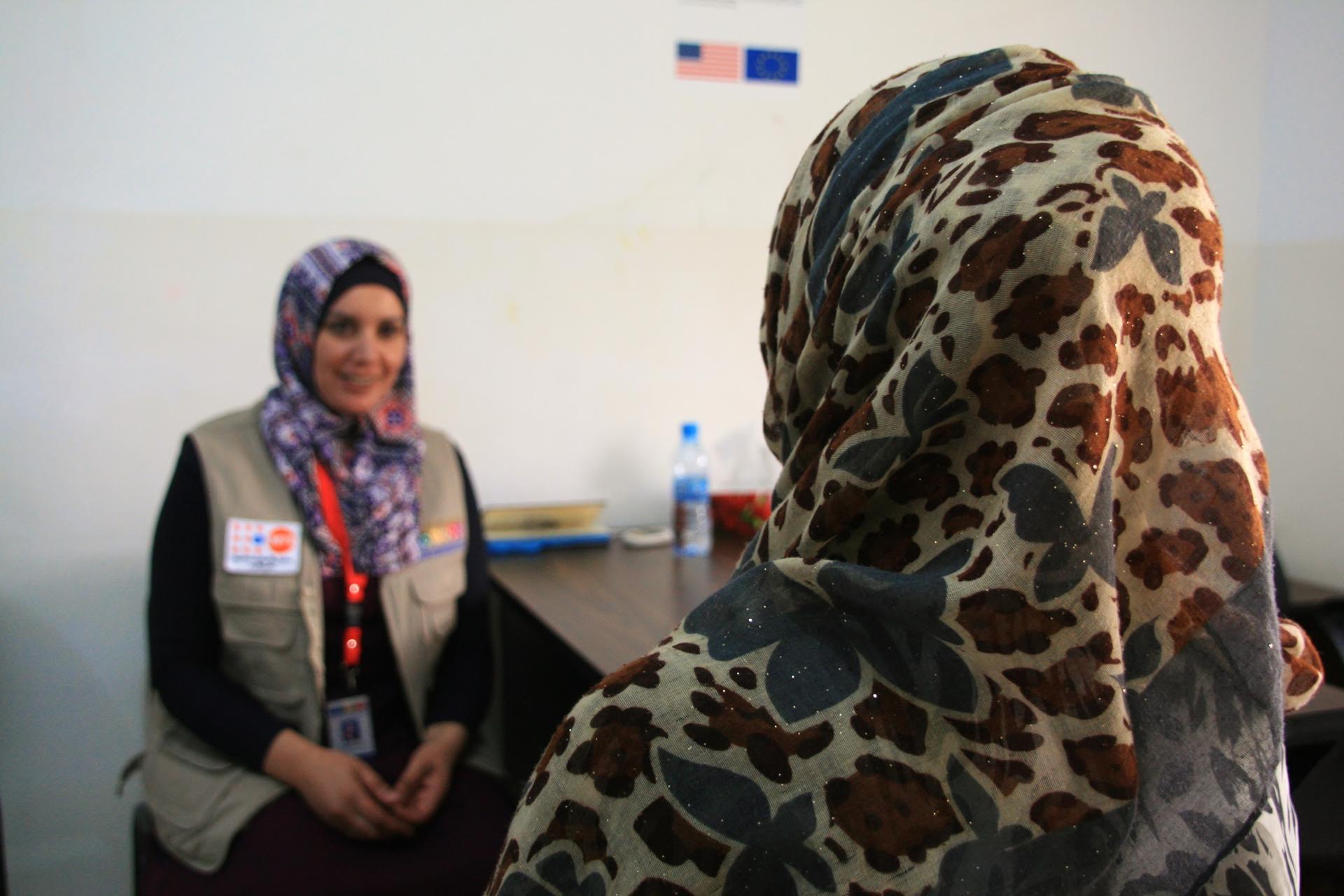 After Noor (right) fled Syria with her family, her husband began to be abusive. She now receives counseling and health services at this women's center in Jordan.