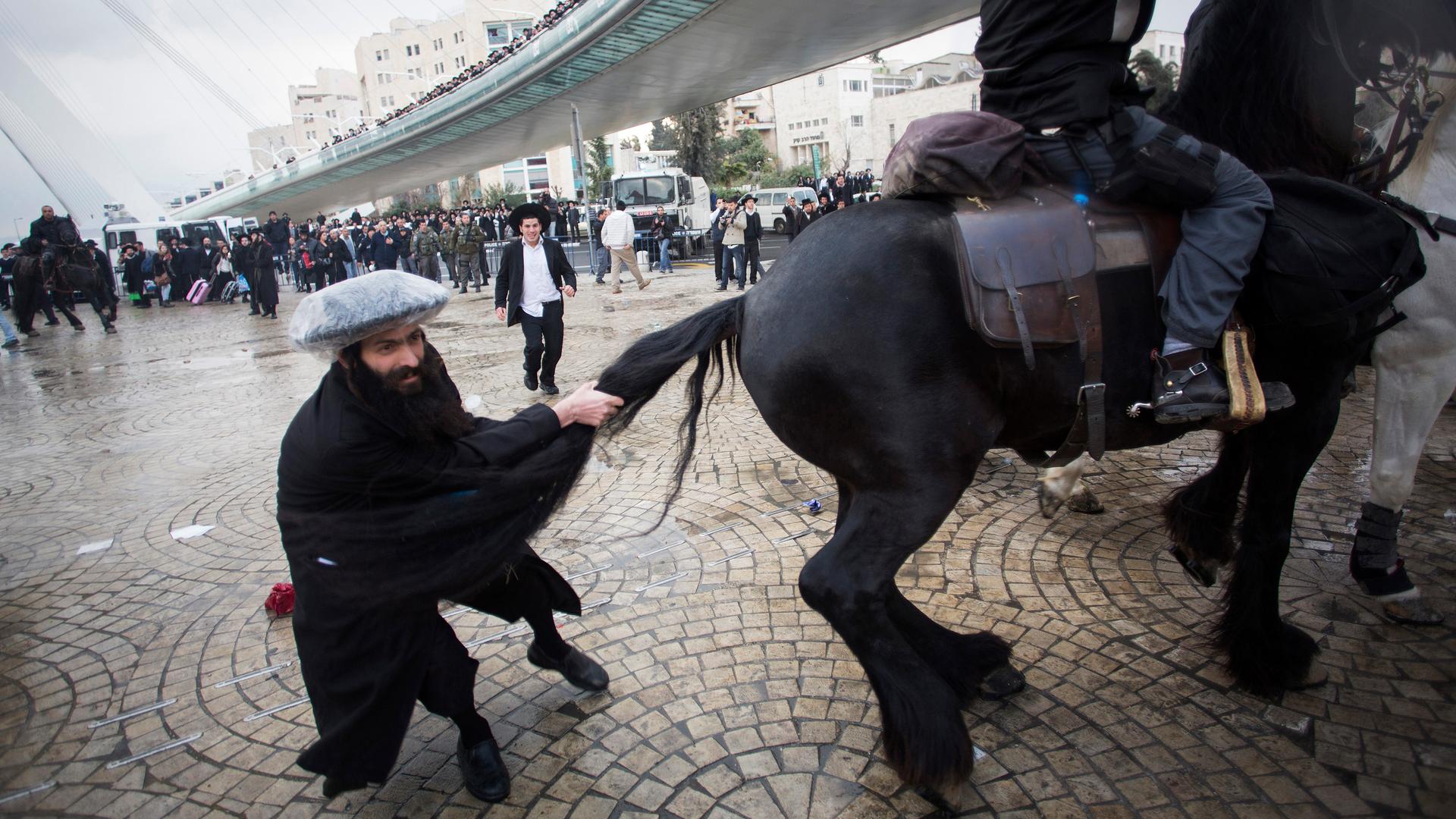 Hundreds of ultra-Orthodox Jews in Israel blocked highways and clashed with police this week to protest a government decision to cut funds to seminary students who avoid military service.
