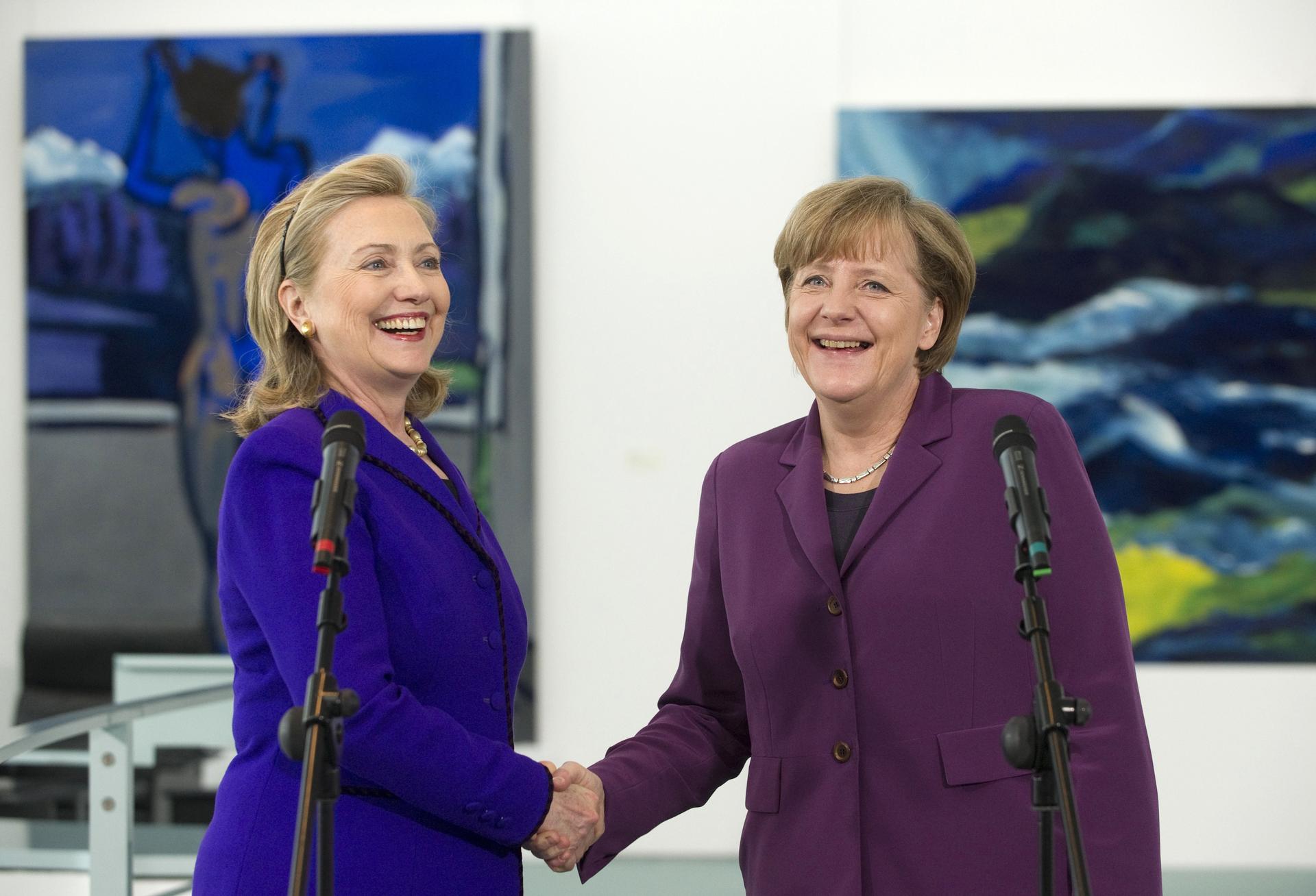German Chancellor Angela Merkel shakes hands with US Secretary of State Hillary Clinton (L) prior to a meeting at the Chancellery in Berlin April 14, 2011.