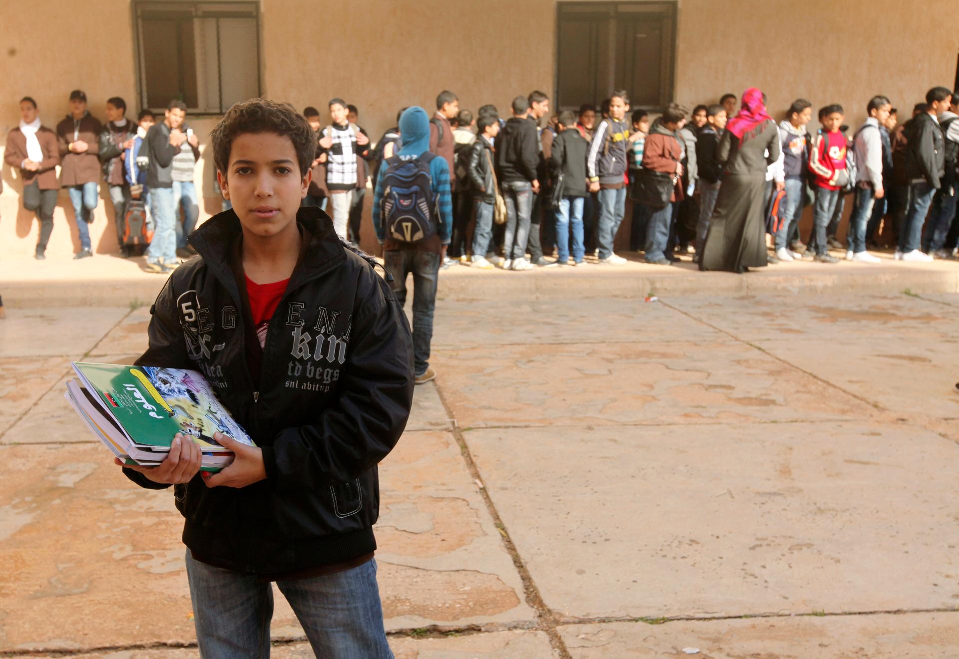 A Libyan student stands with newly received textbooks in Benghazi on January 18, 2012.