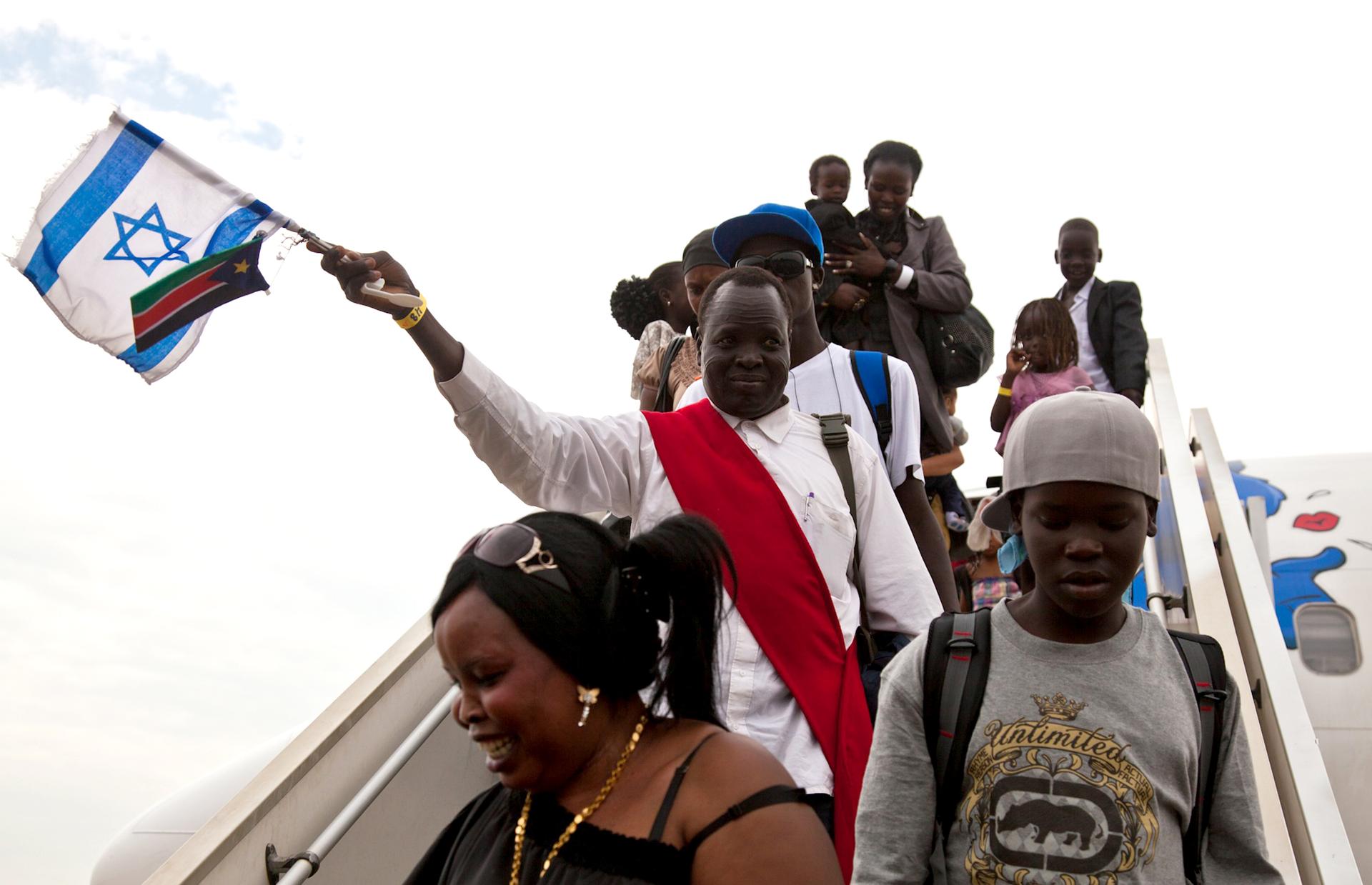 South Sudanese disembark from a plane from Israel after getting deported back to Juba, June 18, 2012.