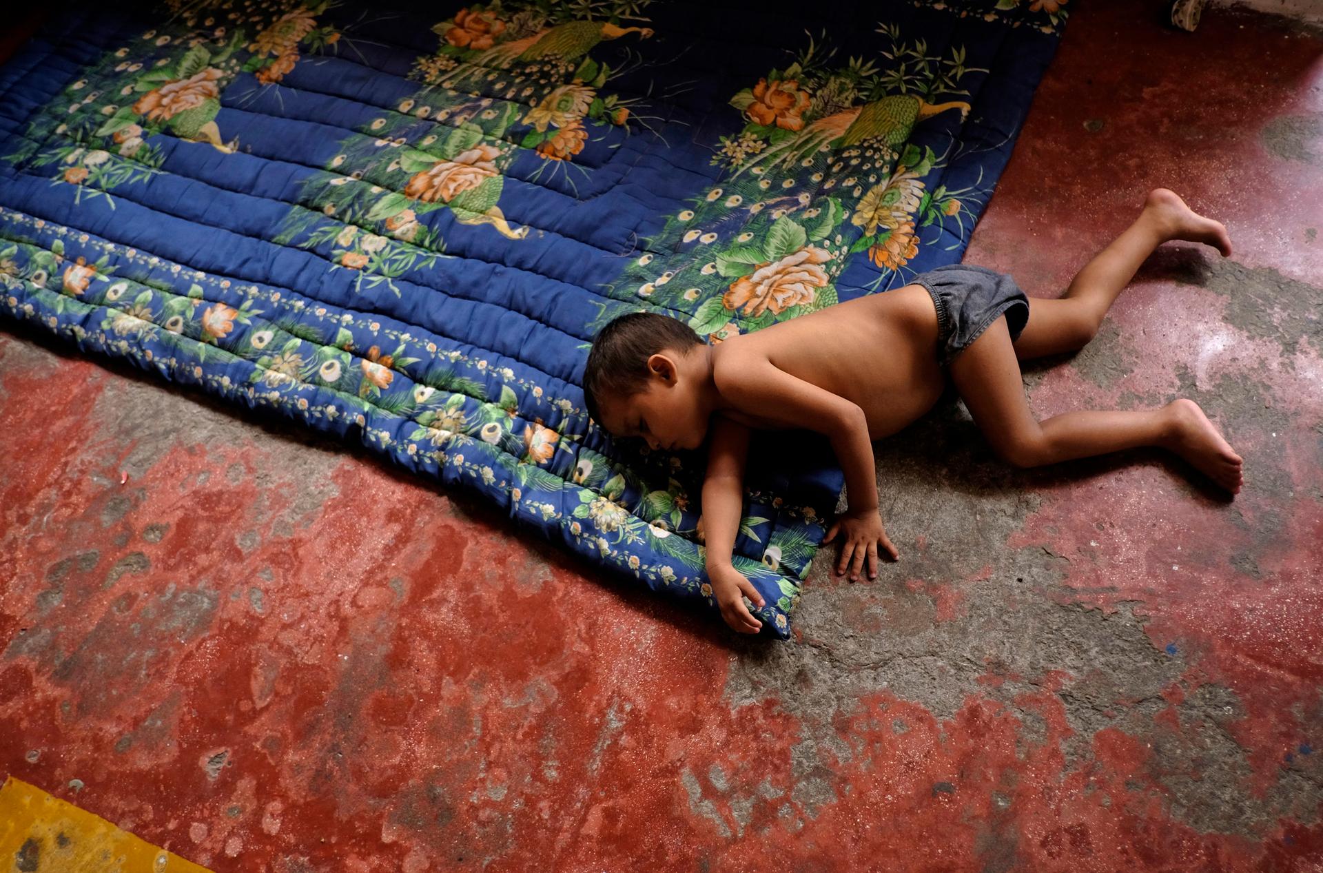 A Honduran child sleeps at an immigrant shelter in Chiapas, in southern Mexico.  His is traveling with his family from his impoverished and violent neighborhood to northern Mexico or the US.