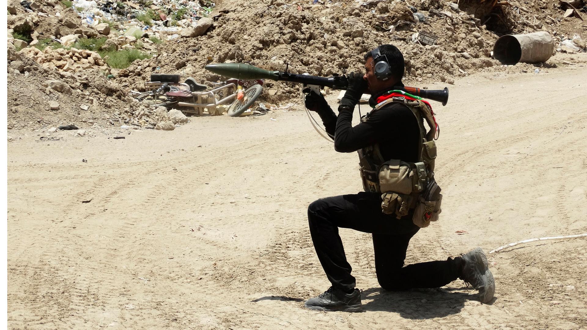 A member of the Iraqi Special Operations Forces (ISOF) takes his position during a patrol looking for militants of the Islamic State, formerly known as the Islamic State of Iraq and the Levant (ISIL), in a neighborhood in Ramadi, July 23, 2014.