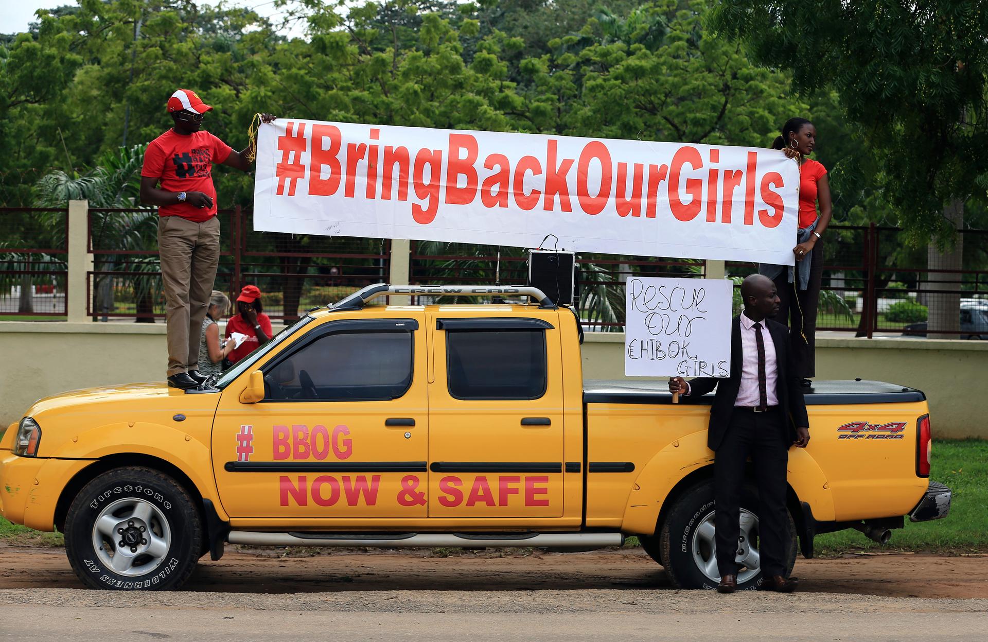 Demonstrators hold up a banner during a rally in Abuja that was held to mark the 120th day since the abduction of 200 schoolgirls by the Boko Haram Islamist groups on August 12, 2014.