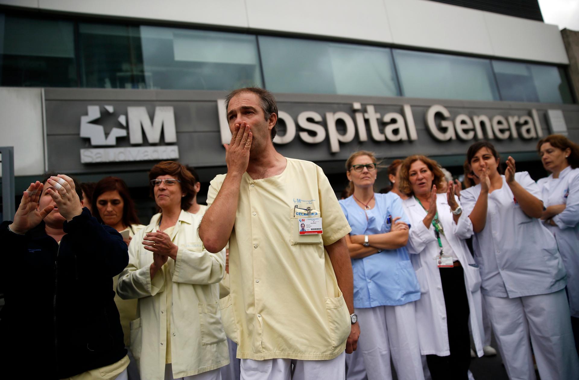 Health workers attend a protest on October 7, 2014, outside Madrid's La Paz Hospital calling for Spain's health minister, Ana Mato, to resign after a Spanish nurse contracted Ebola.