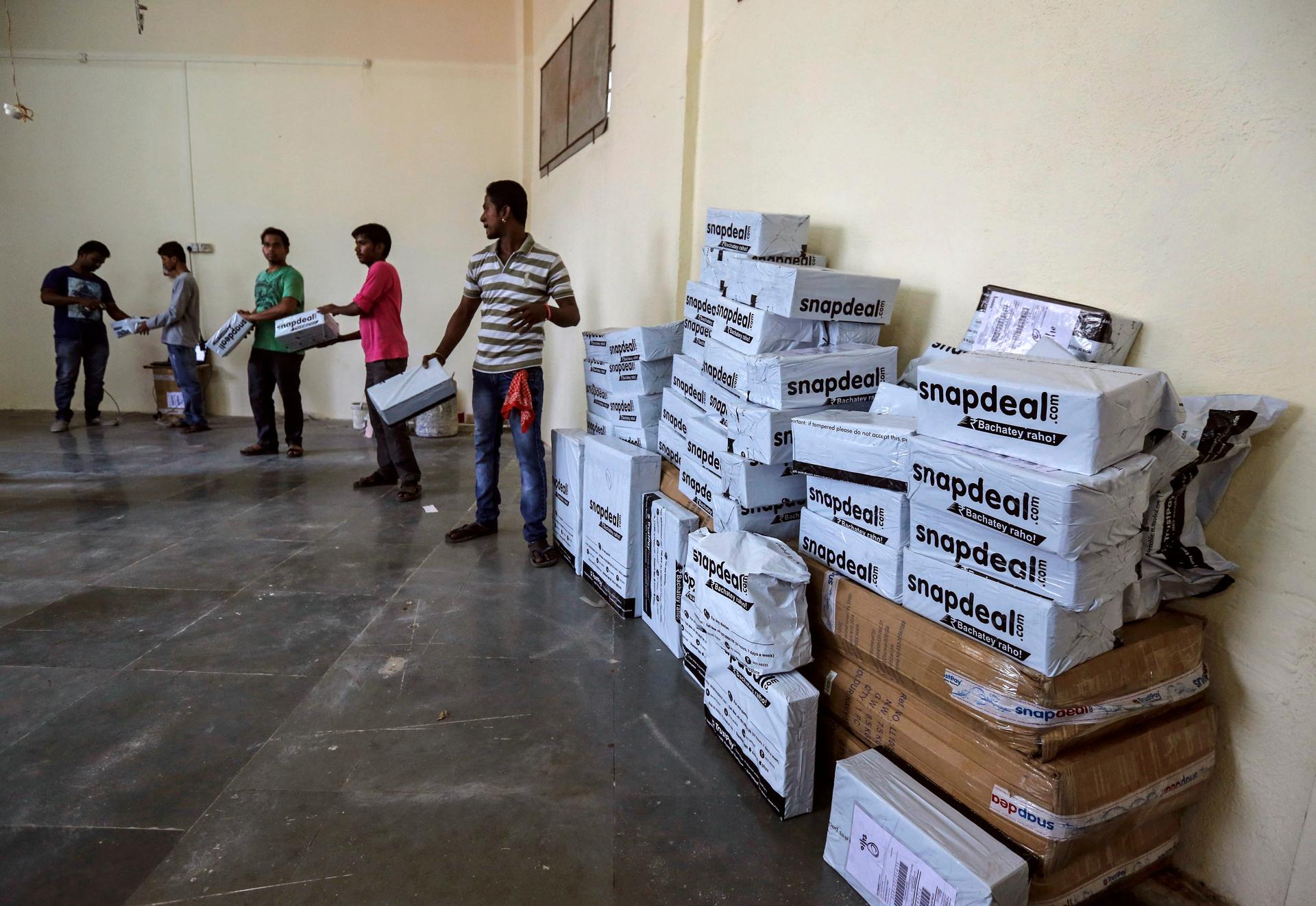 Employees of Snapdeal, an Indian online retailer, sort out delivery packages inside their company fulfillment center in Mumbai on October 22, 2014.
