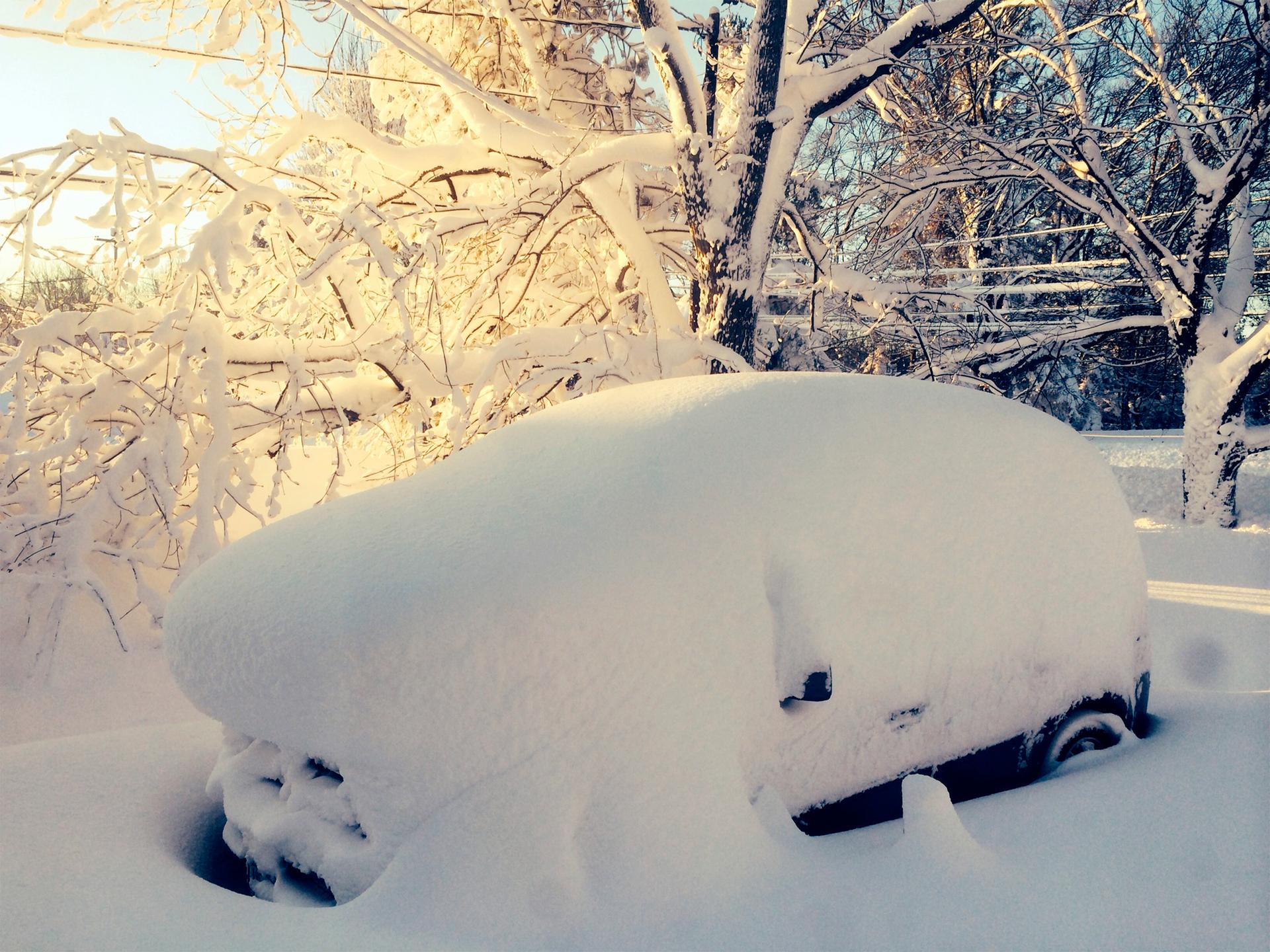 A car is covered in snow in Orchard Park outside of Buffalo, New York, November 19, 2014.