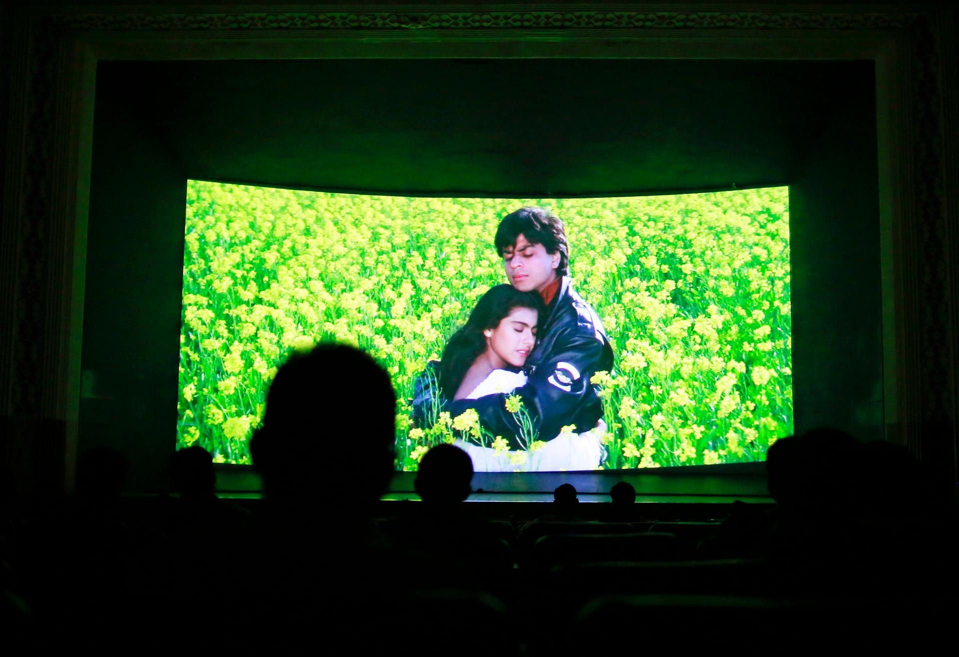 Inside the Mumbai theater, moviegoers look at the screen.