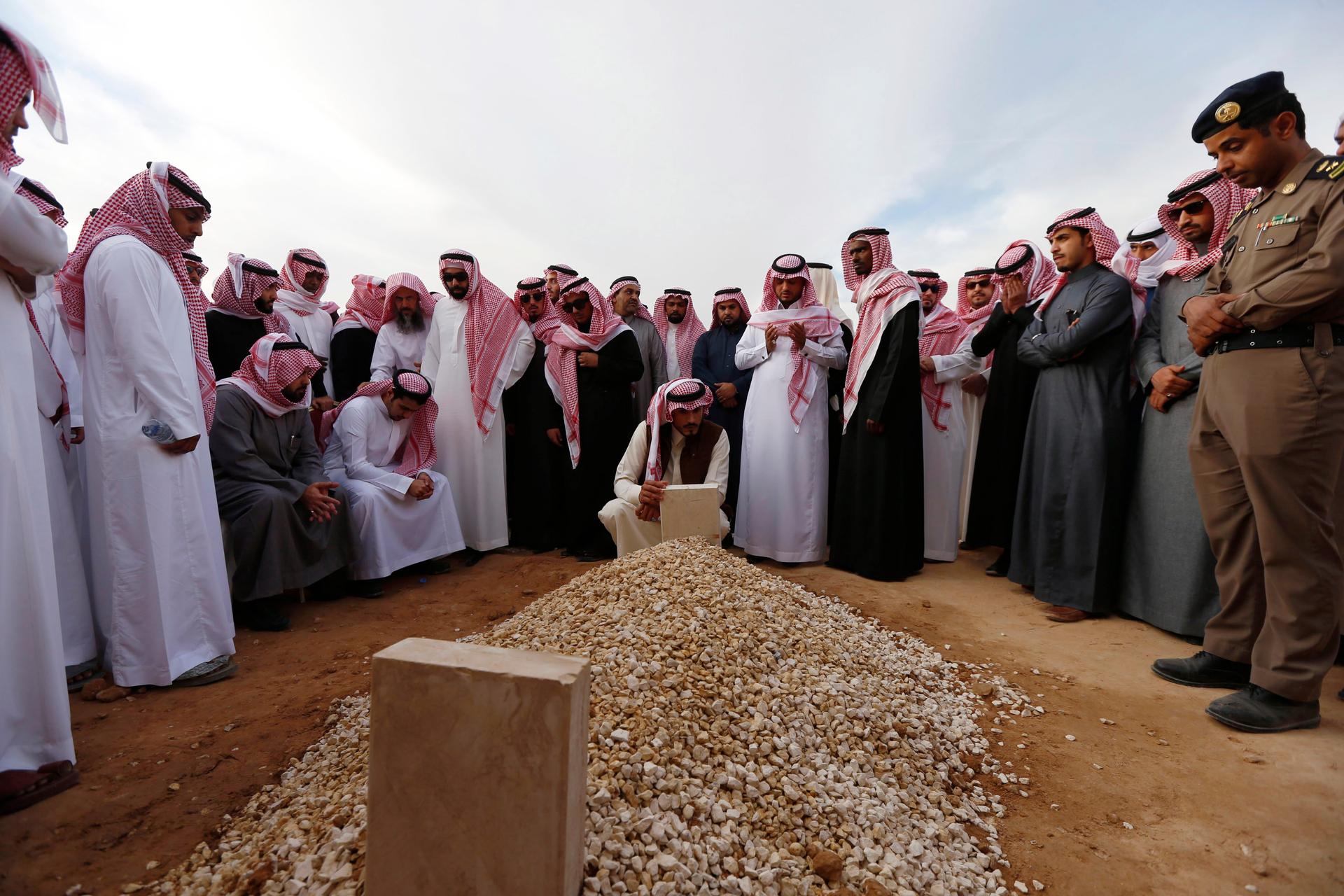 Mourners gather around the grave of Saudi King Abdullah following his burial in Riyadh on Friday.