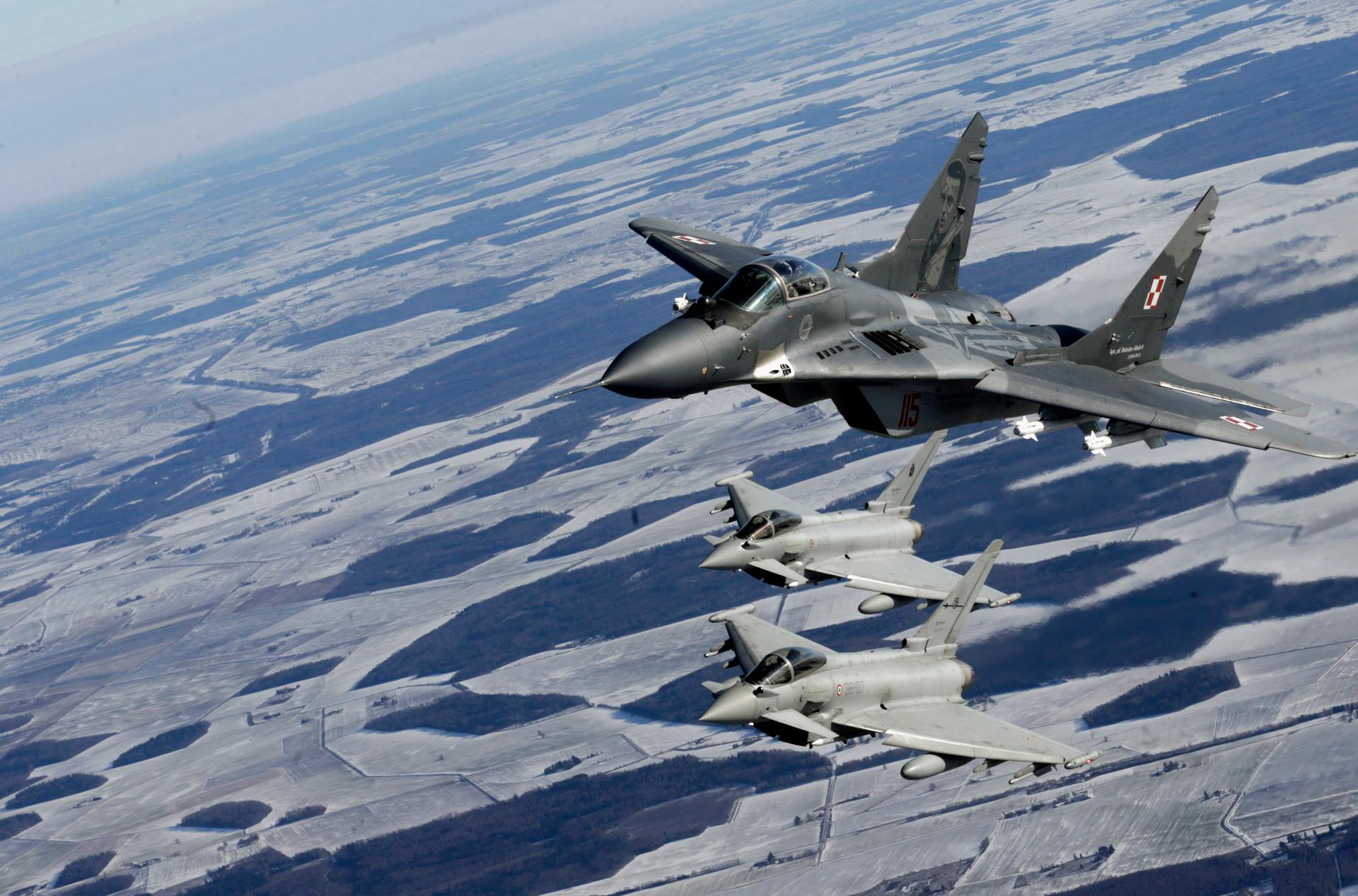A Polish Air Force MIG-29 fighter and Italian Air Force Eurofighter Typhoon fighters participate during a NATO air policing mission patrol over the Baltics on February 10, 2015.