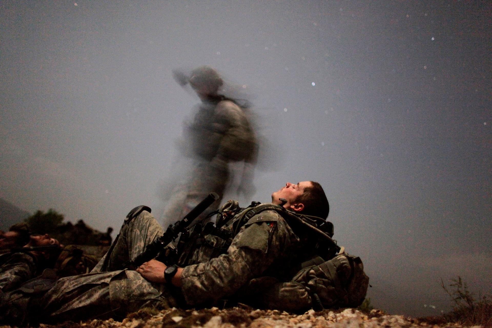 A US soldier of 2-12 Infantry Task Force Mountain Warrior takes a break during a night mission near Honaker Miracle camp at the Pesh valley of Kunar Province.