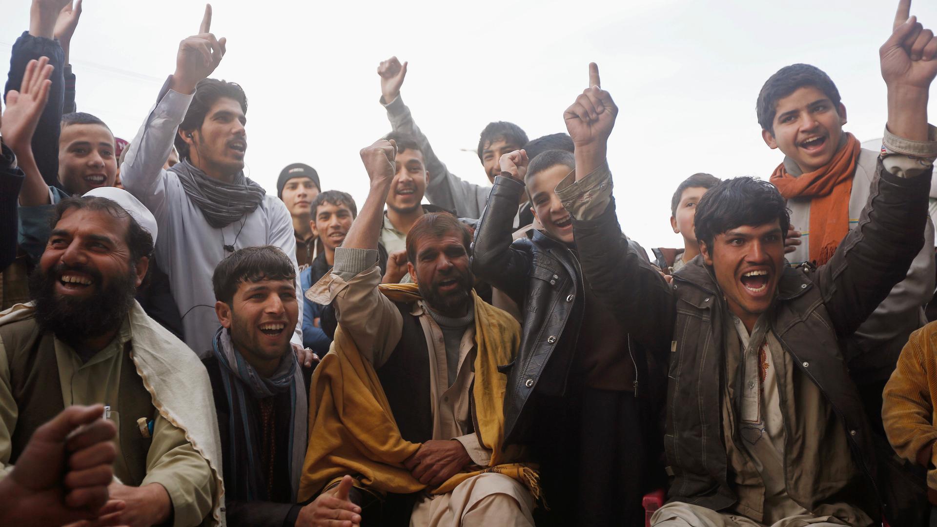 Afghan fans watch the live broadcast of a Cricket World Cup match at a roadside stall in Kabul.